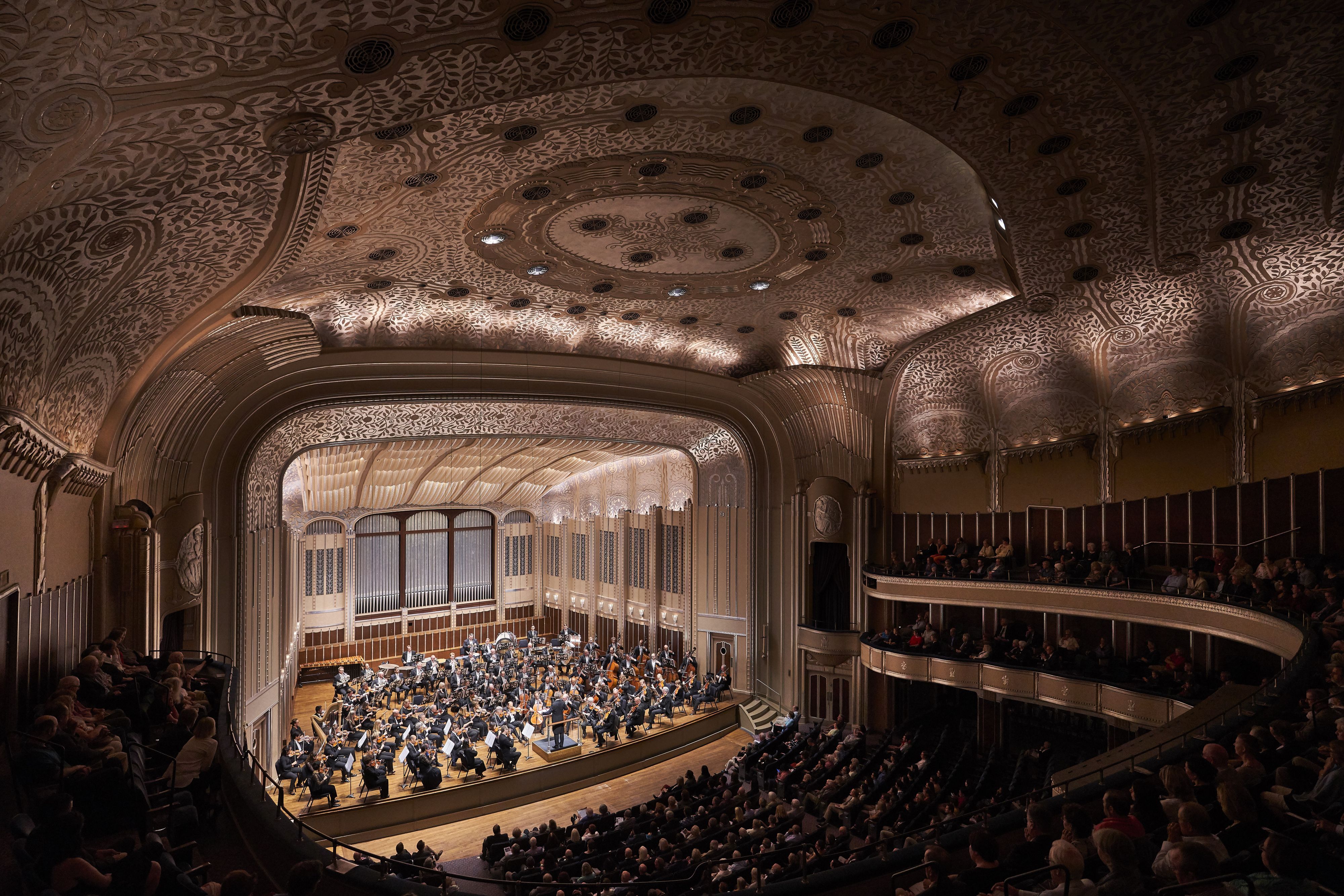 Audience seated inside the historic Palace Theatre.