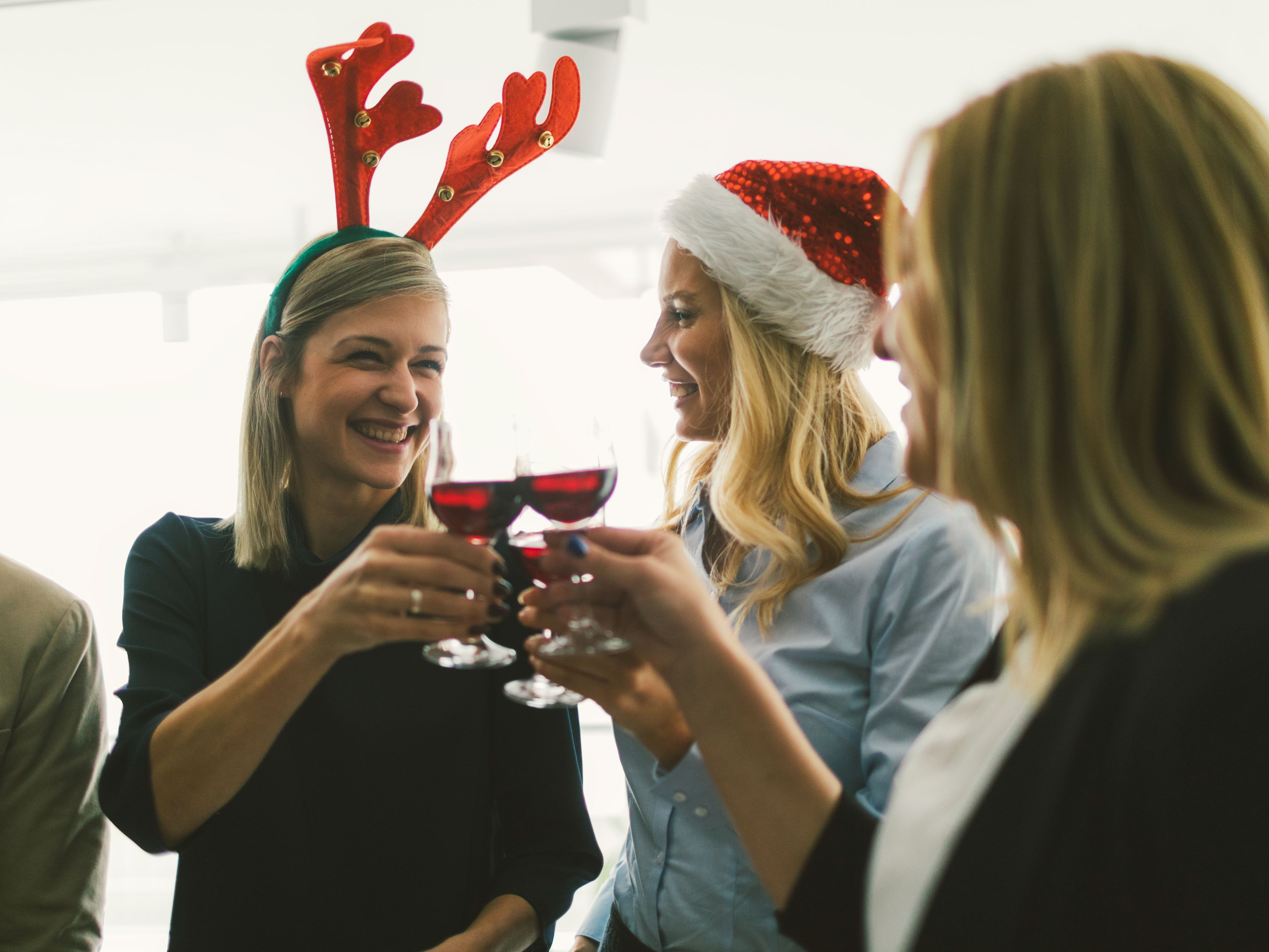 Group of friends toasting at a holiday party.