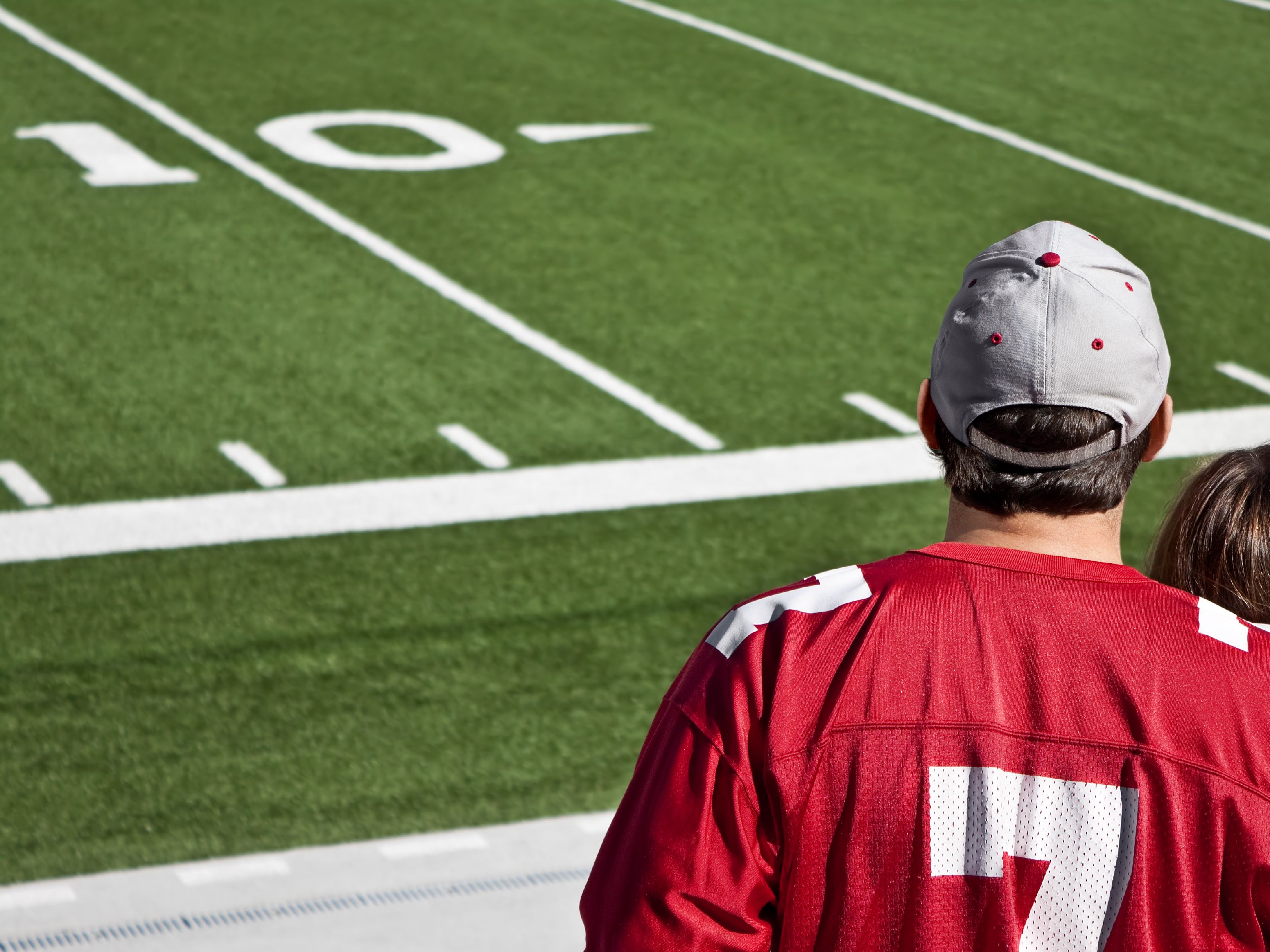 College fan on football field sidelines