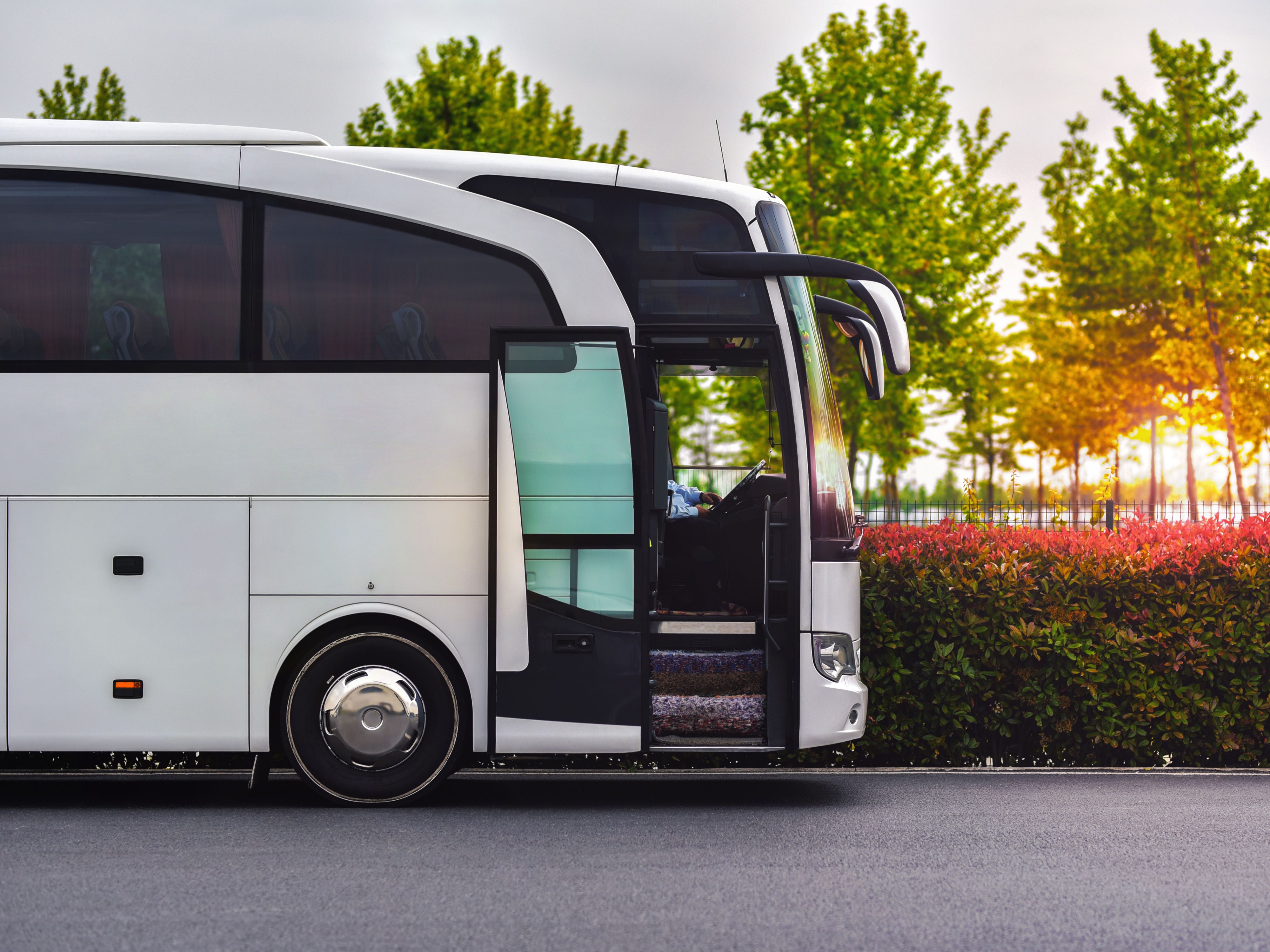 Coach bus parked at sunset