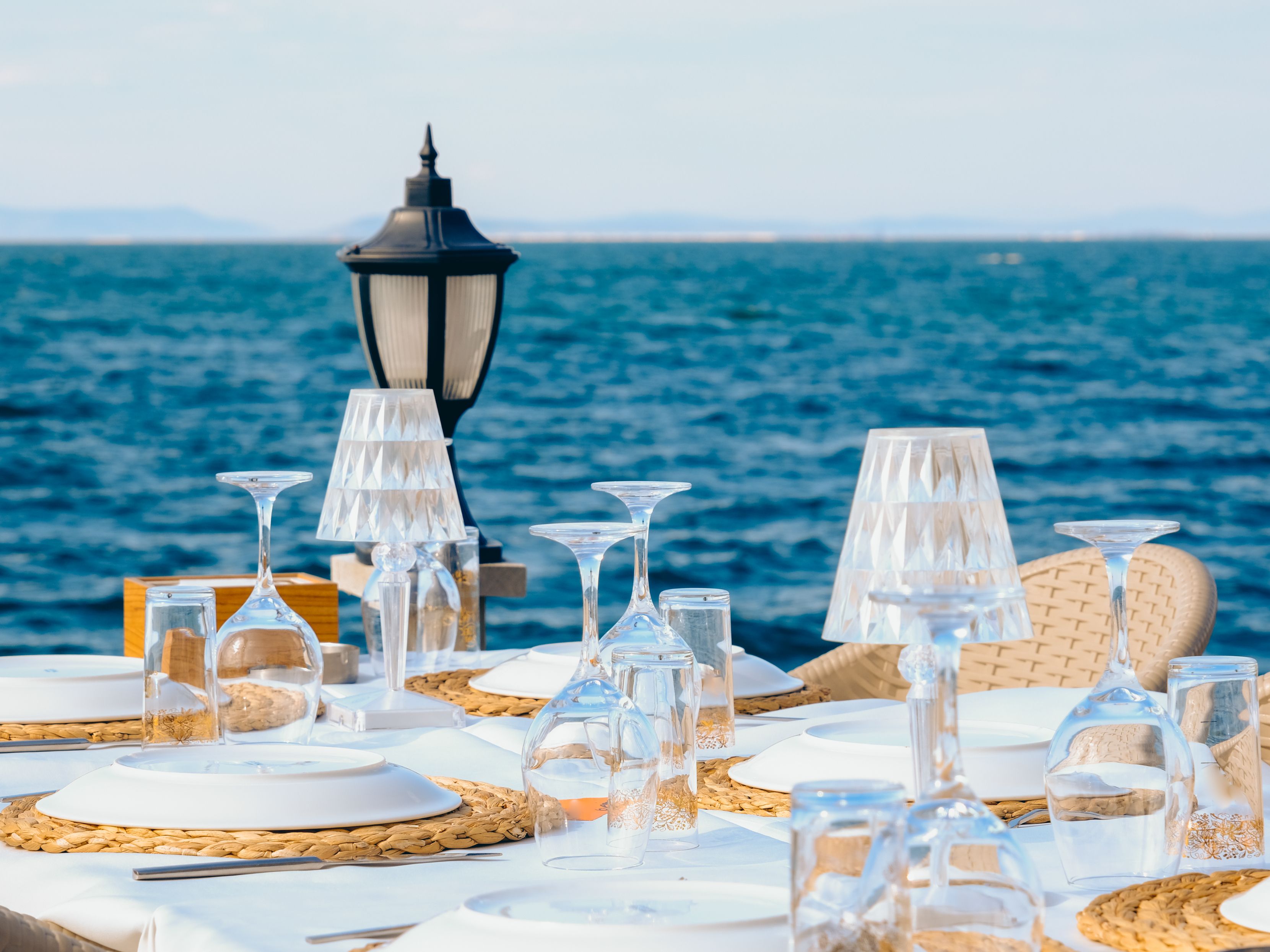Table set up with dishes and an ocean view