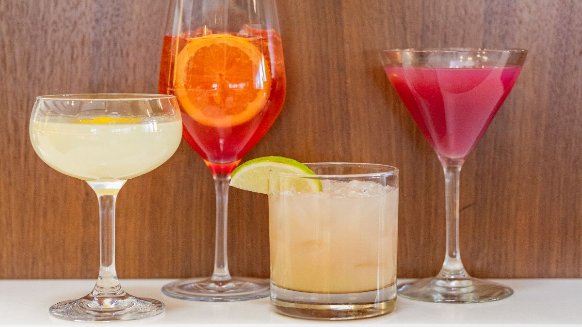 Four cocktails lined up on the bar