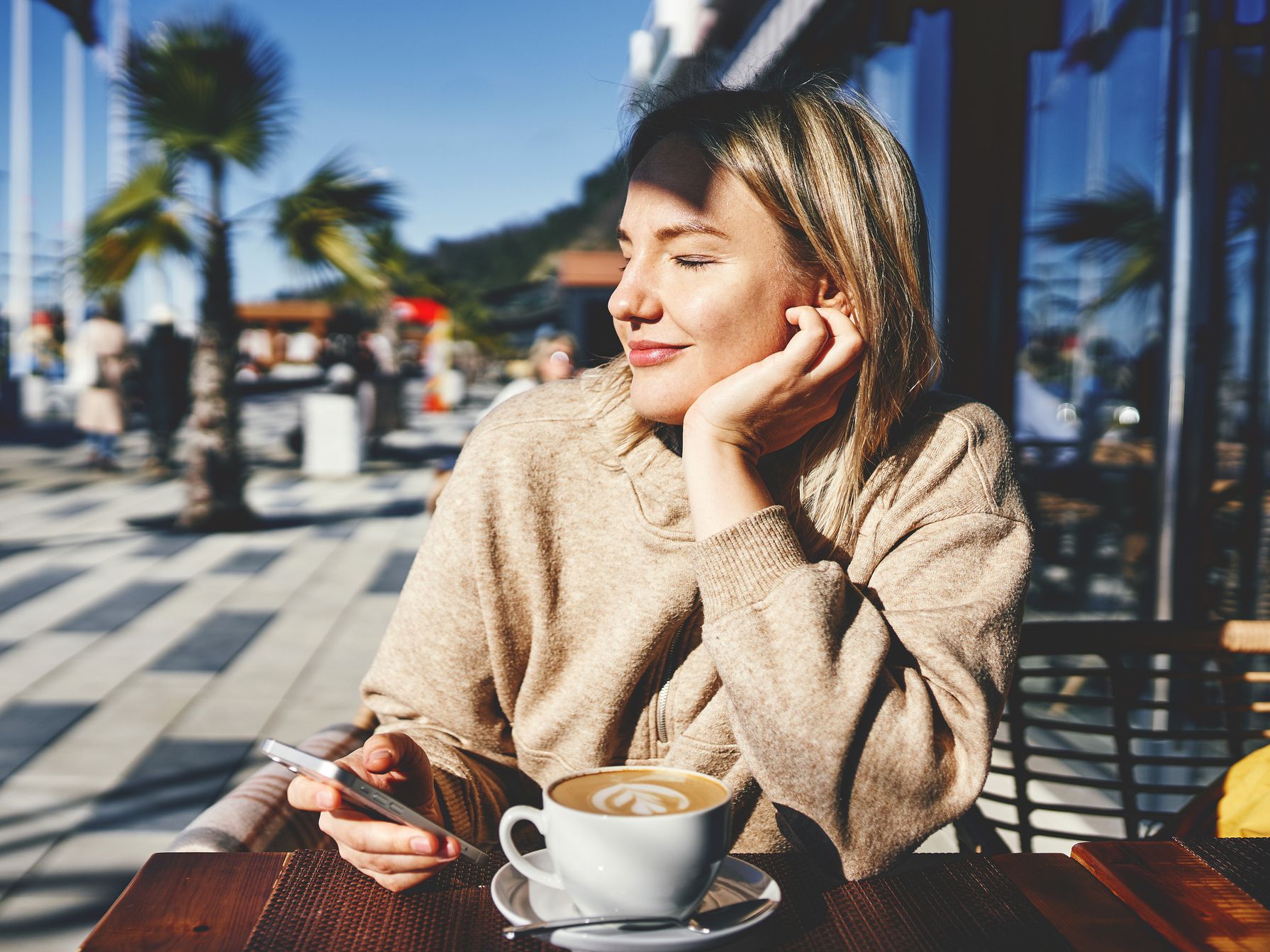 Lady sitting at a coffee shop  enjoing her coffee