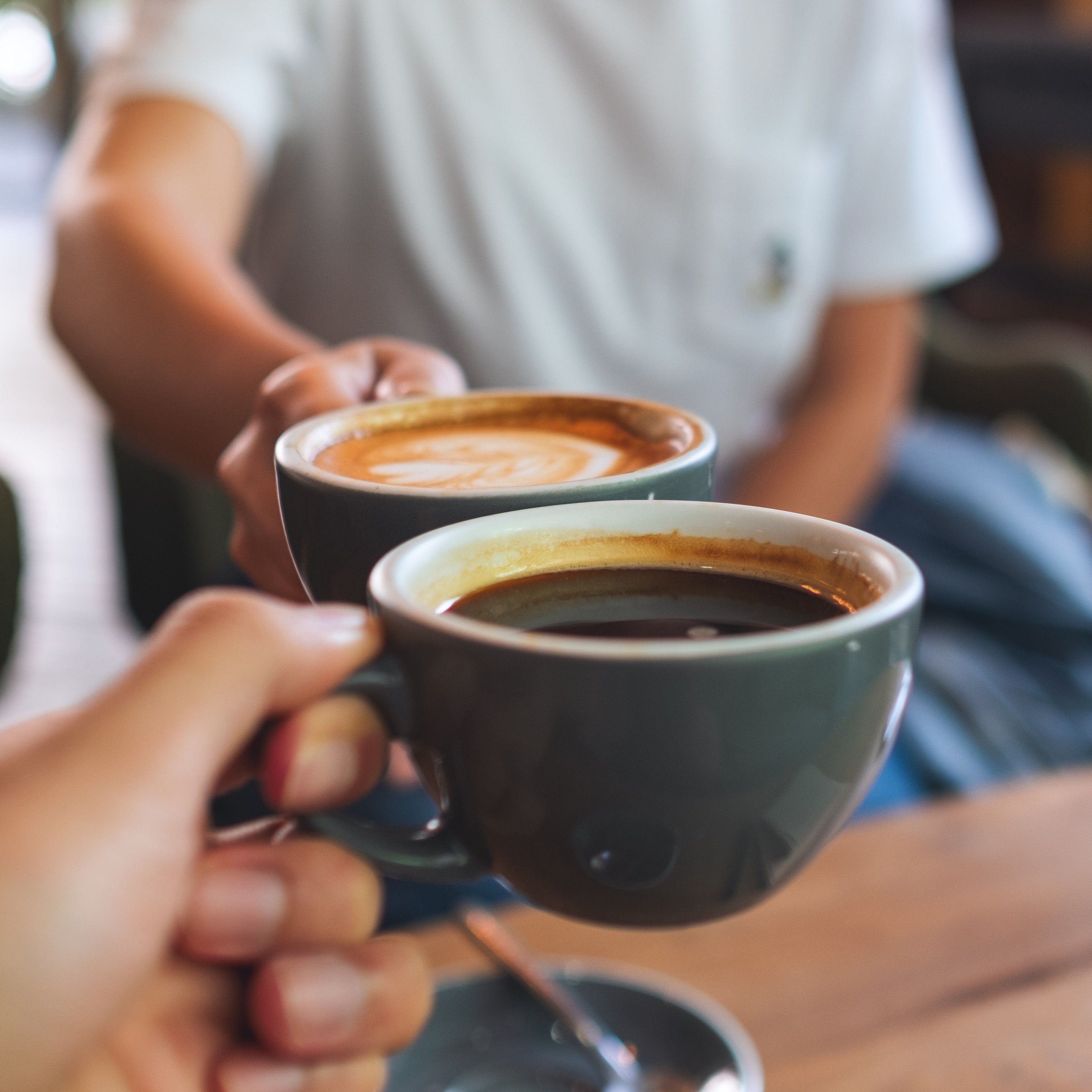 Friends toasting coffee