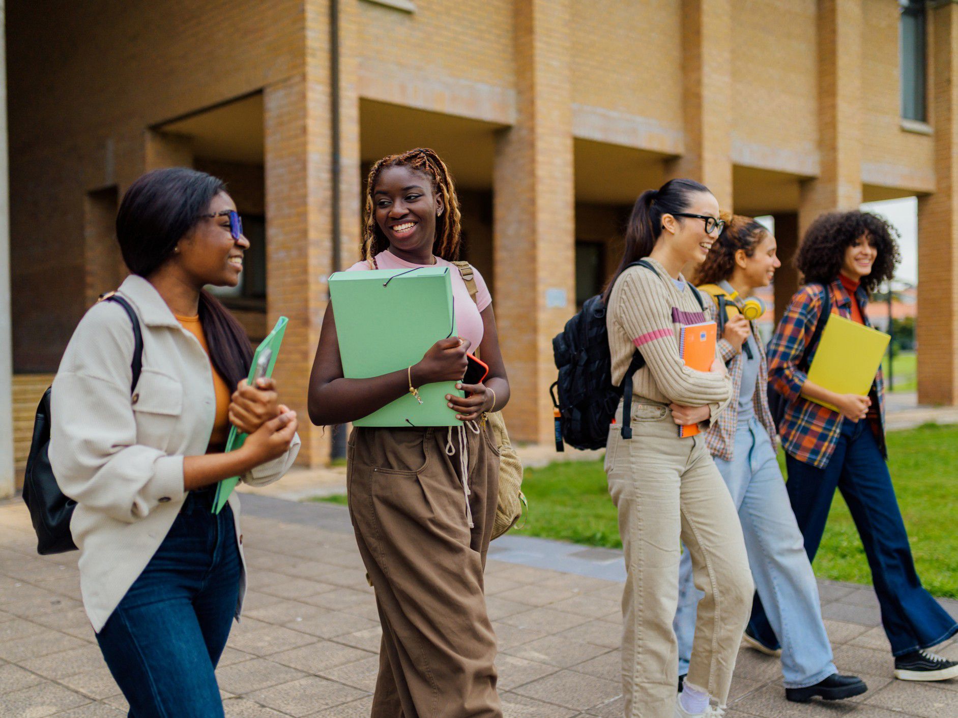 Students walking and talking on campus.