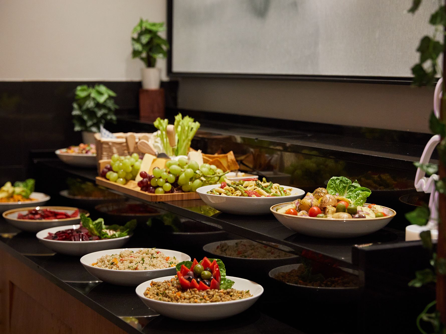 Plates/platters of food buffet, fruit, salads