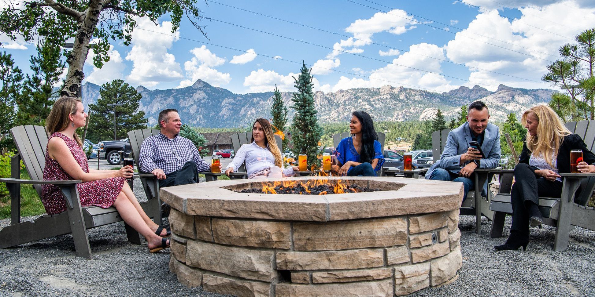 Guests enjoying drinks around outdoor fire pit
