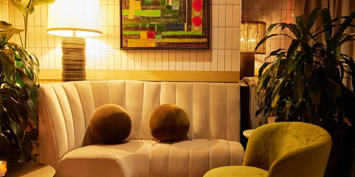 Seating area with couch in the Aliya restaurant lobby