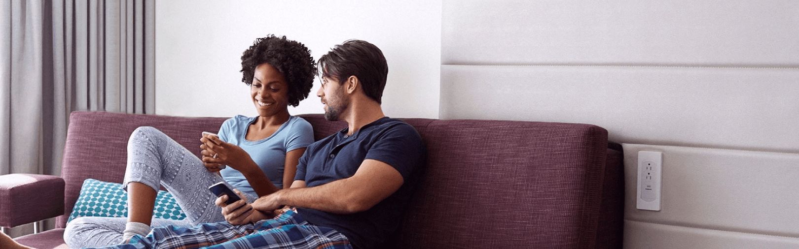 Man and woman sitting on couch in room