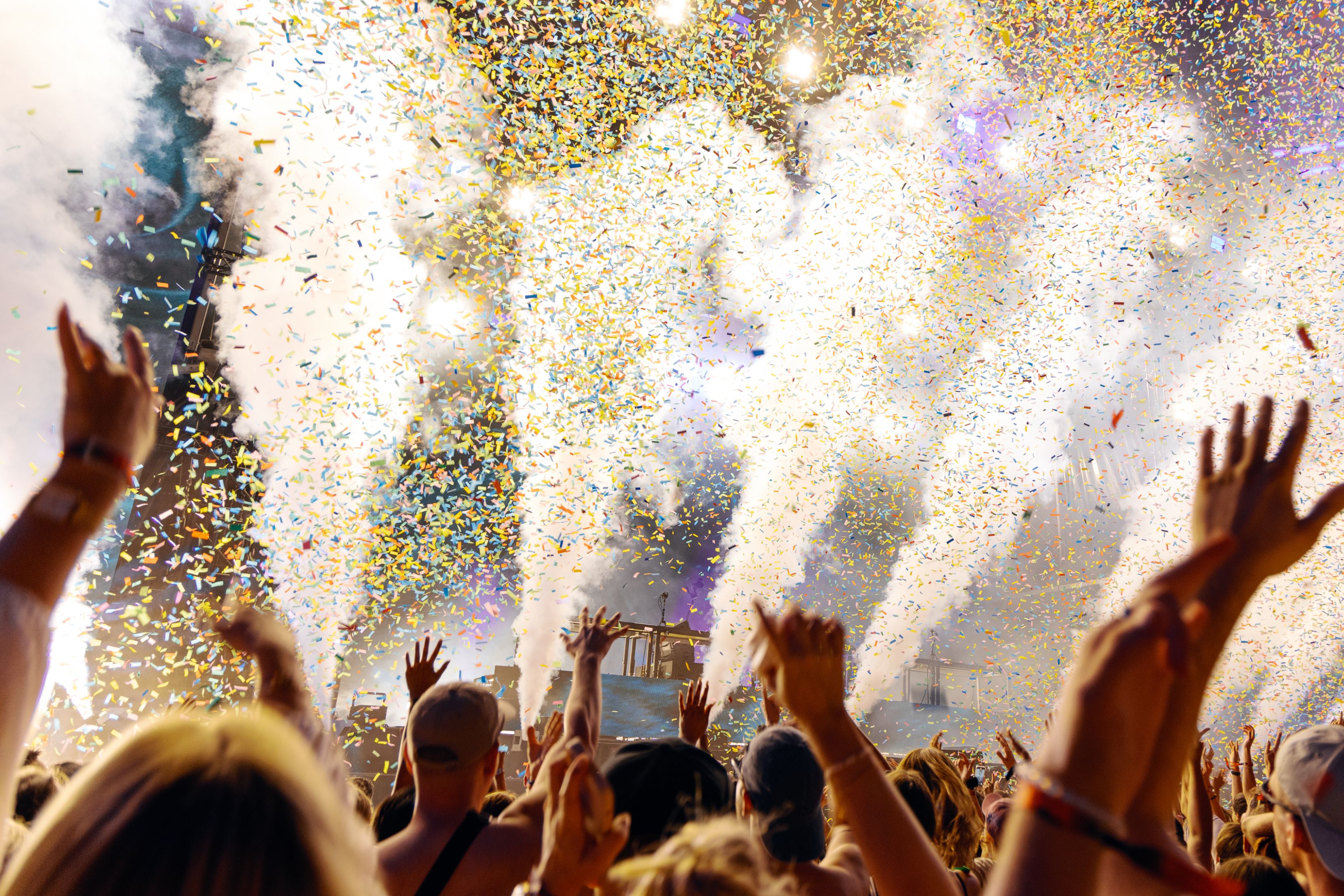 Crowd and confetti at music festival.