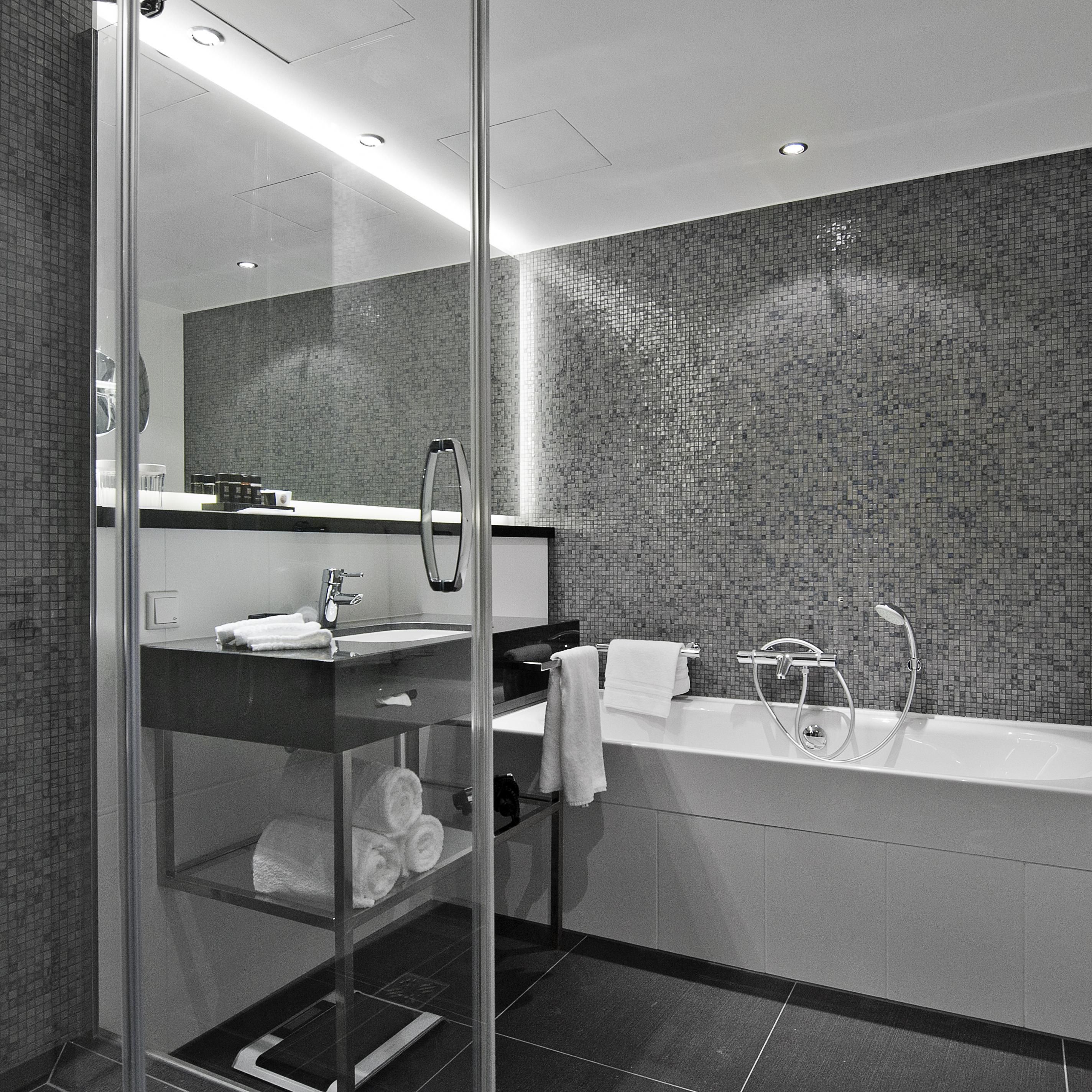 A modern and large guest bathroom in one of the Suites
