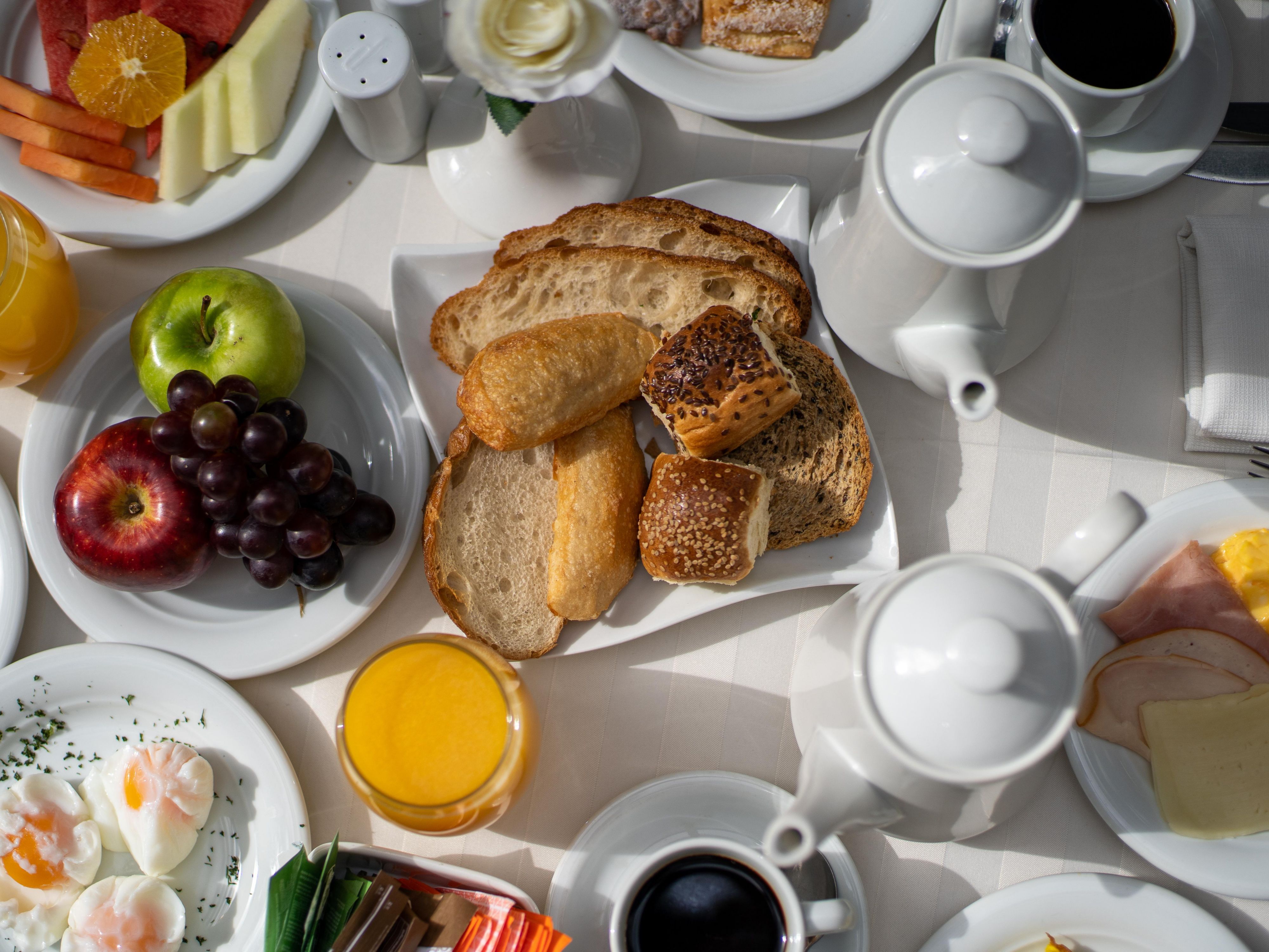 Continental buffet breakfast in downtown Asunción, featuring a diverse selection including hot dishes and options for those with gluten intolerance.