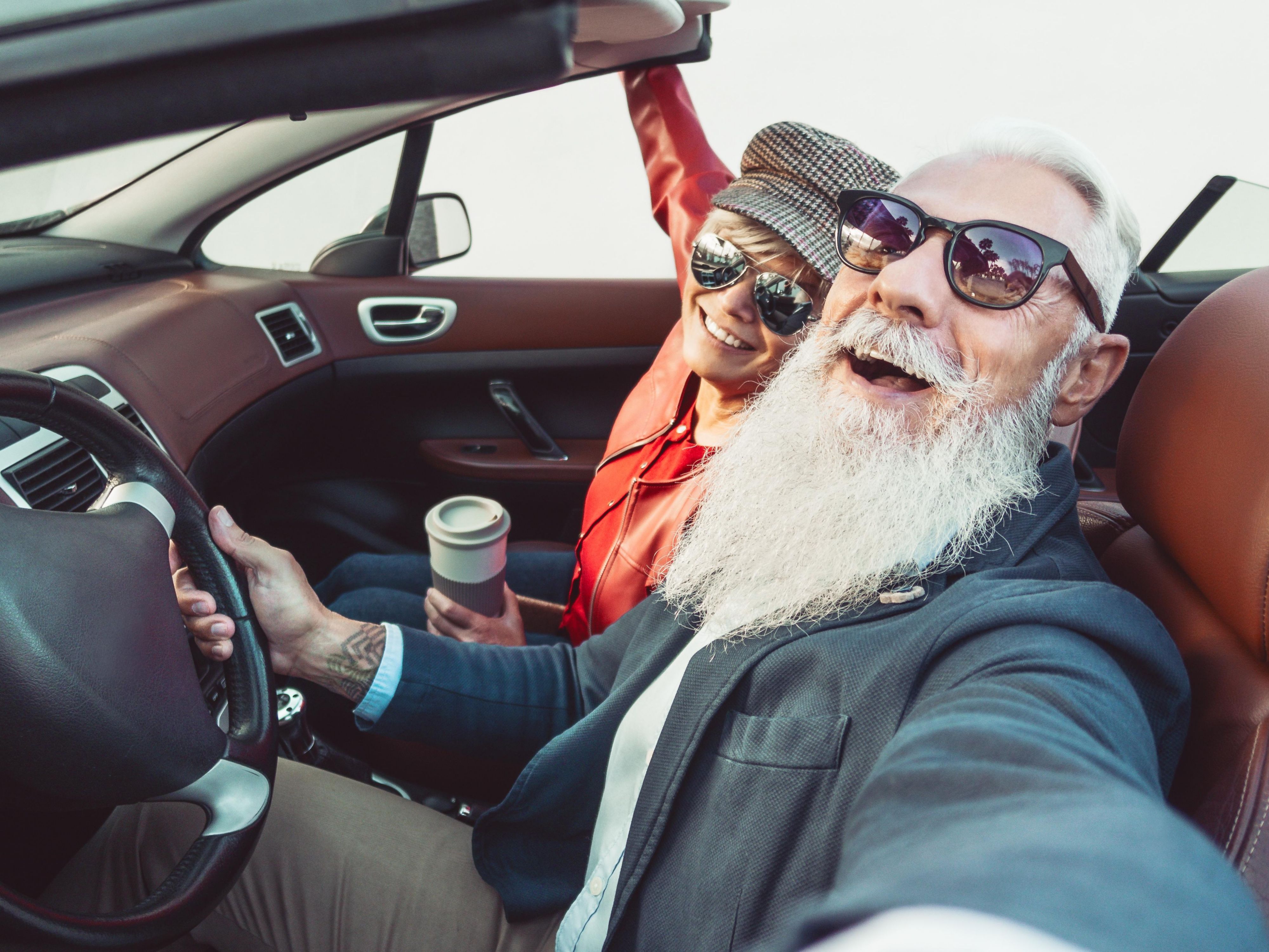 older couple taking a selfie in the car