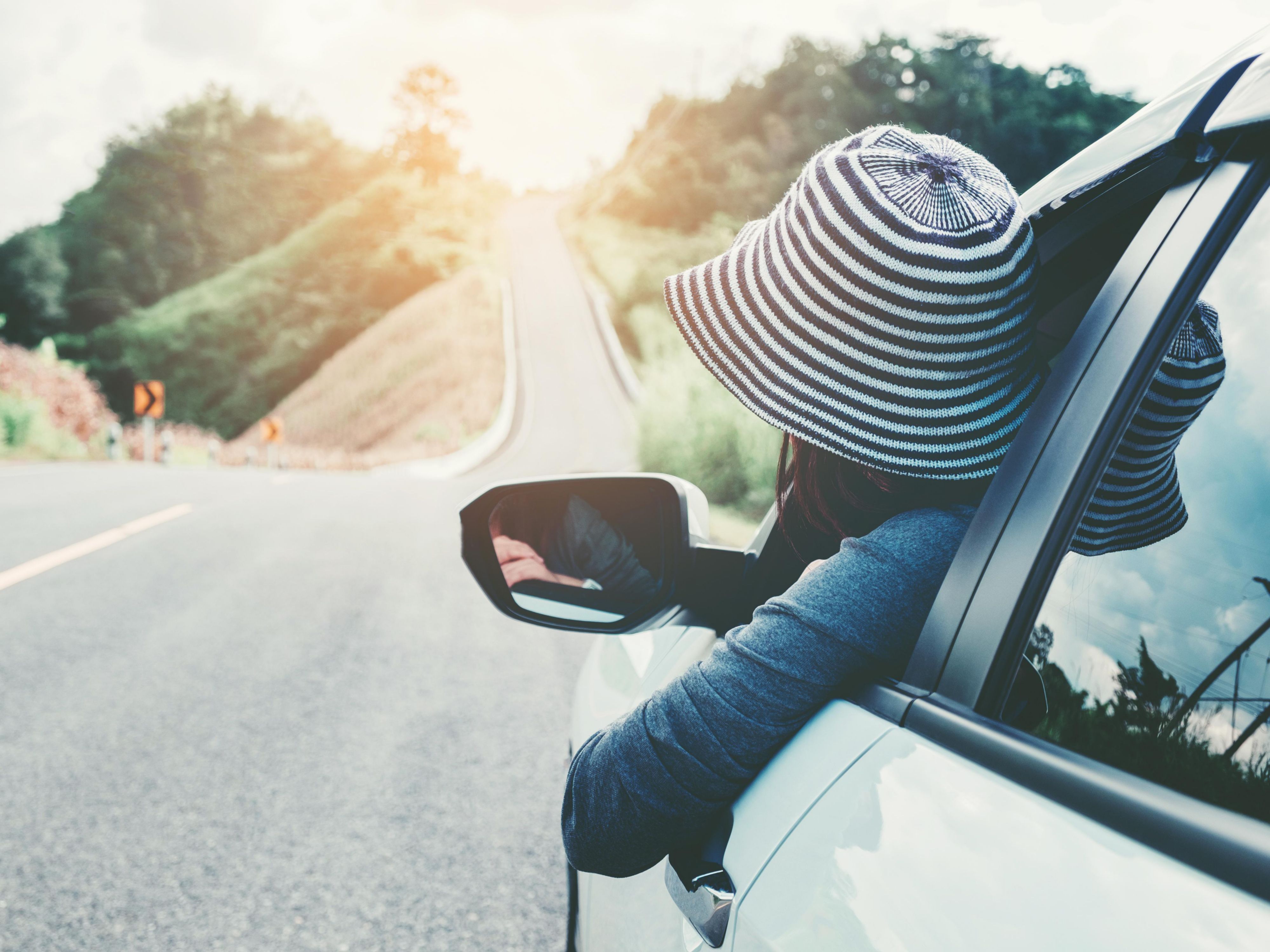 woman driving with head out the window