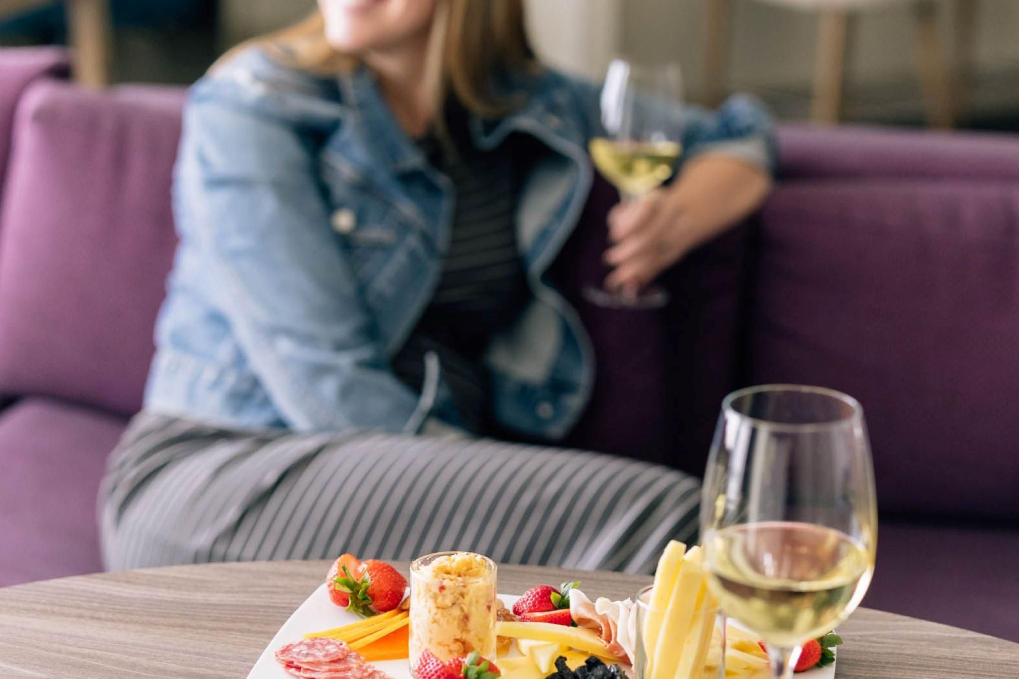 Guest enjoying a glass of wine and a snack