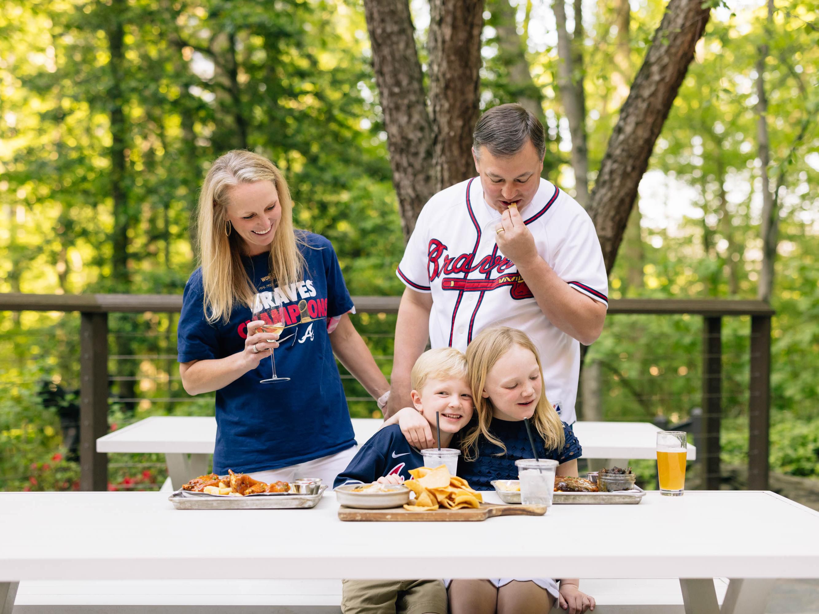 Family picnic in park during Braves Game 