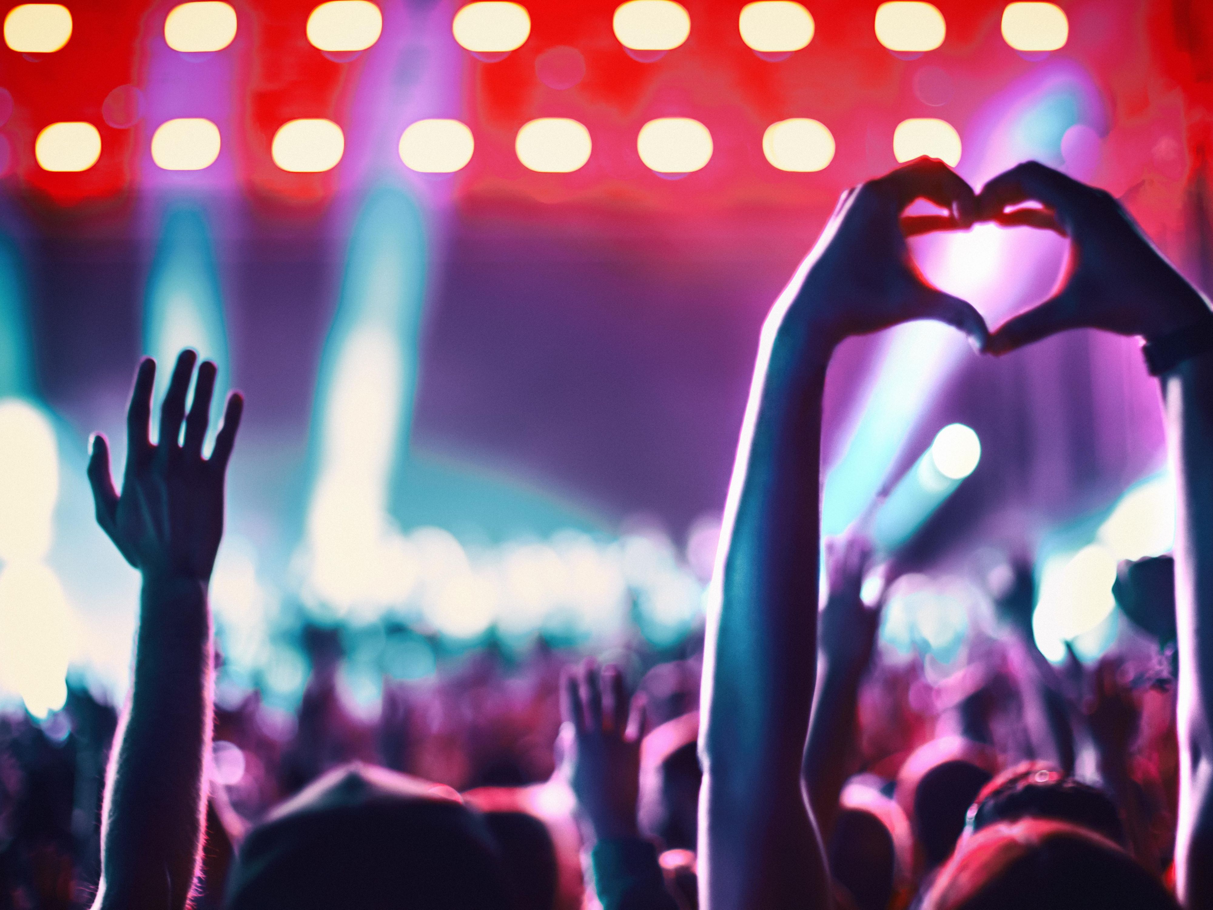 Crowd cheering at stadium concert