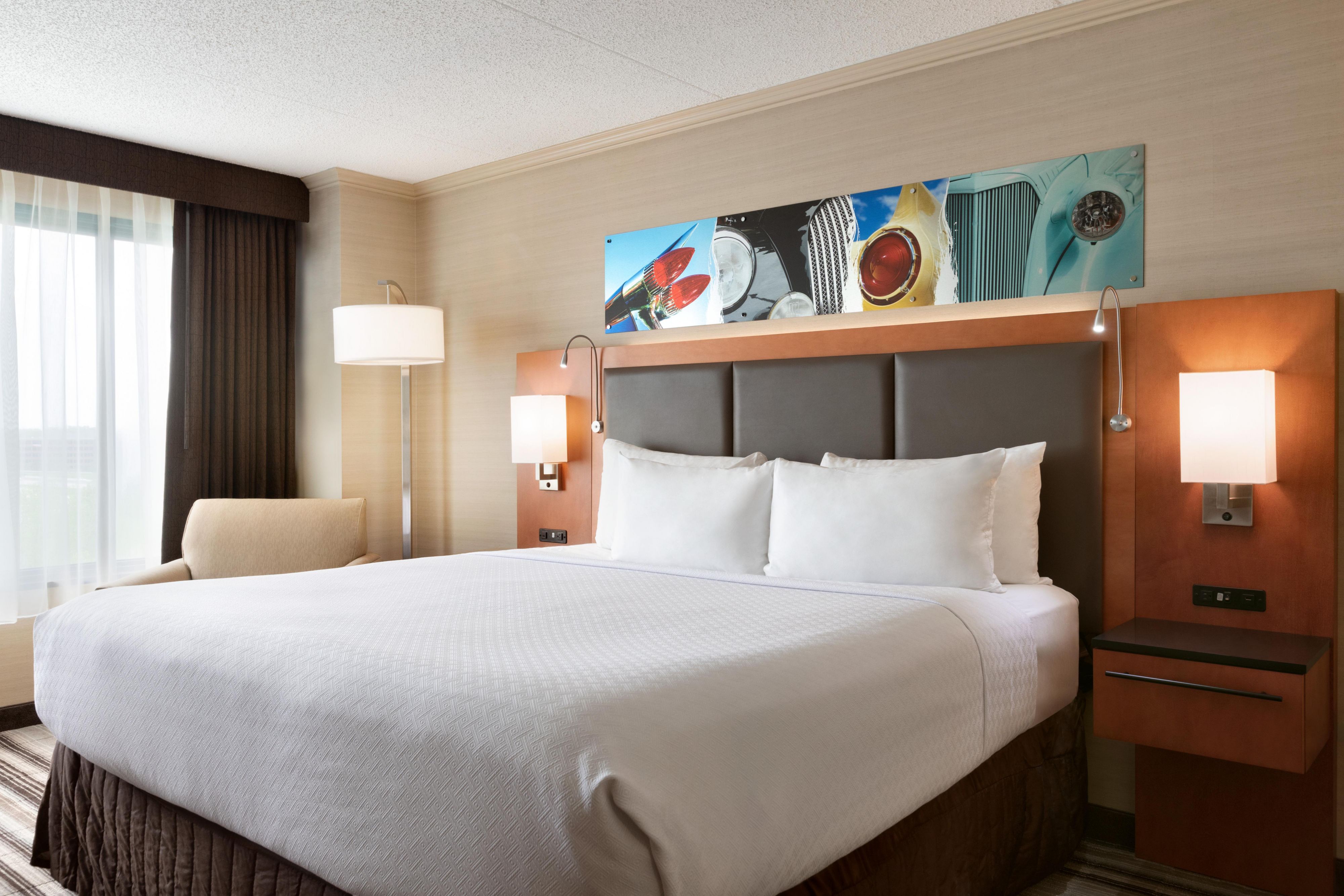 Enjoy plush comfort with pops of color in our standard guest room.