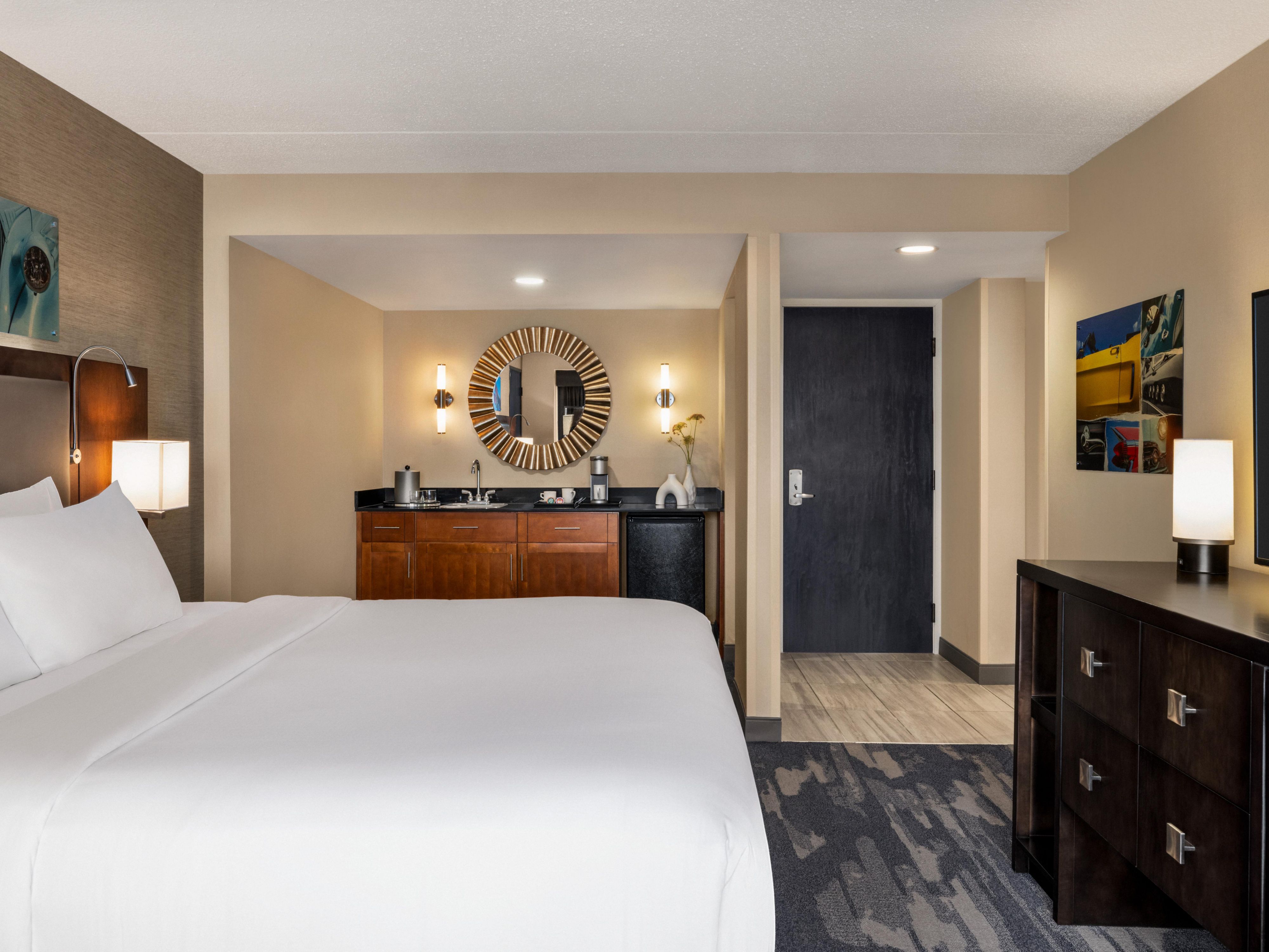 Hotel suite with kitchen area and king bed