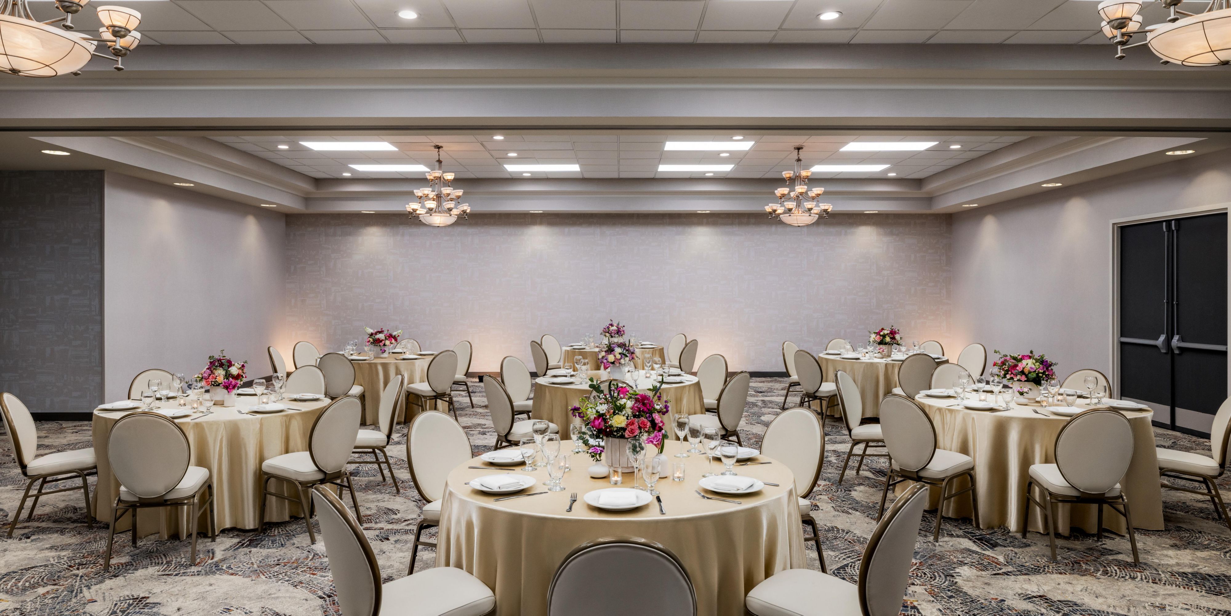 Ballroom set up with round tables and decor