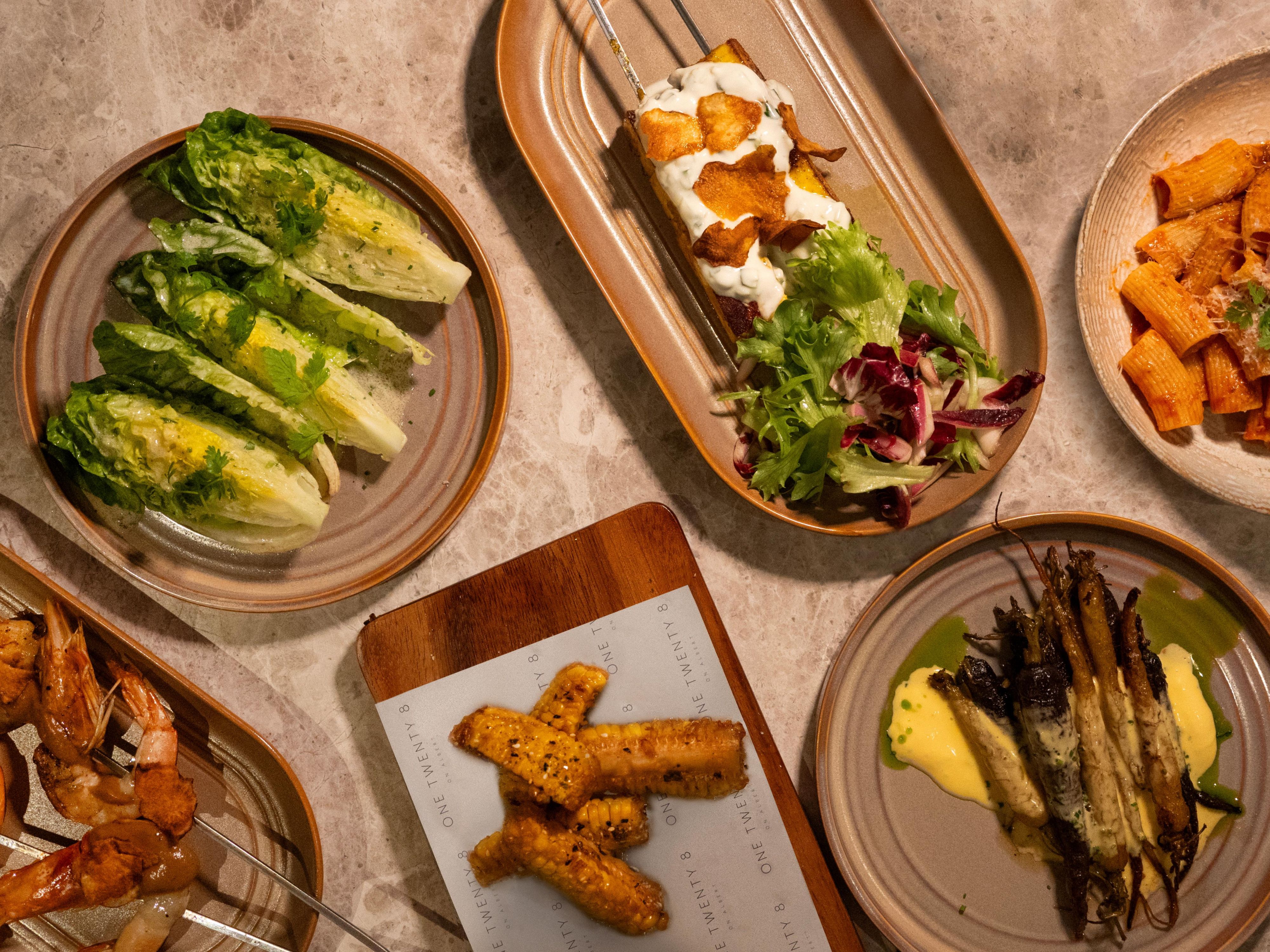 One Twenty 8 is a bold new dining destination where flame, smoke, and the finest local ingredients take centre stage. Our menu is grounded in the power of fire, all while honouring a deep connection to land and sea.

Located adjacent to the Lobby