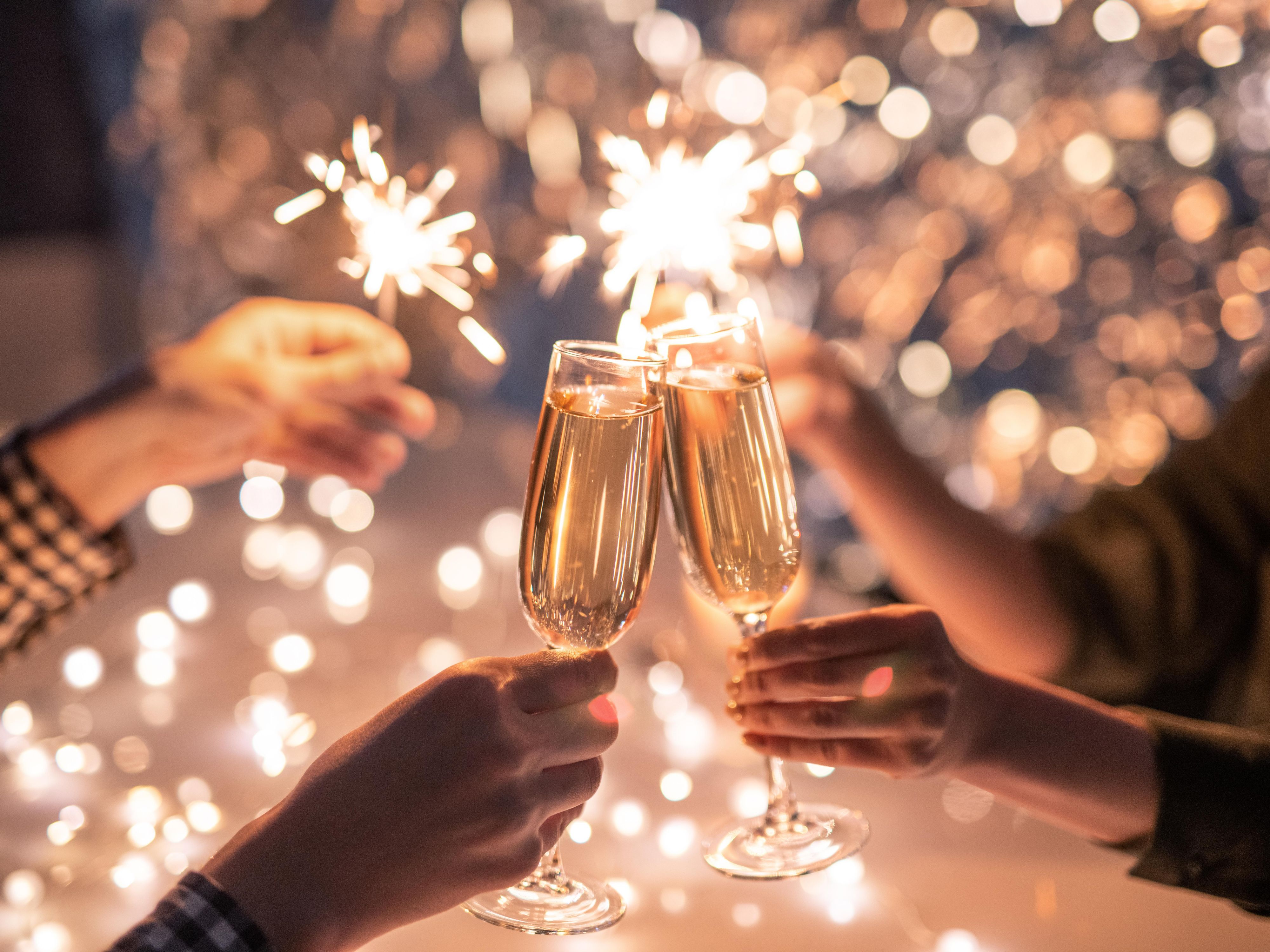 Cheers with champagne and sparklers