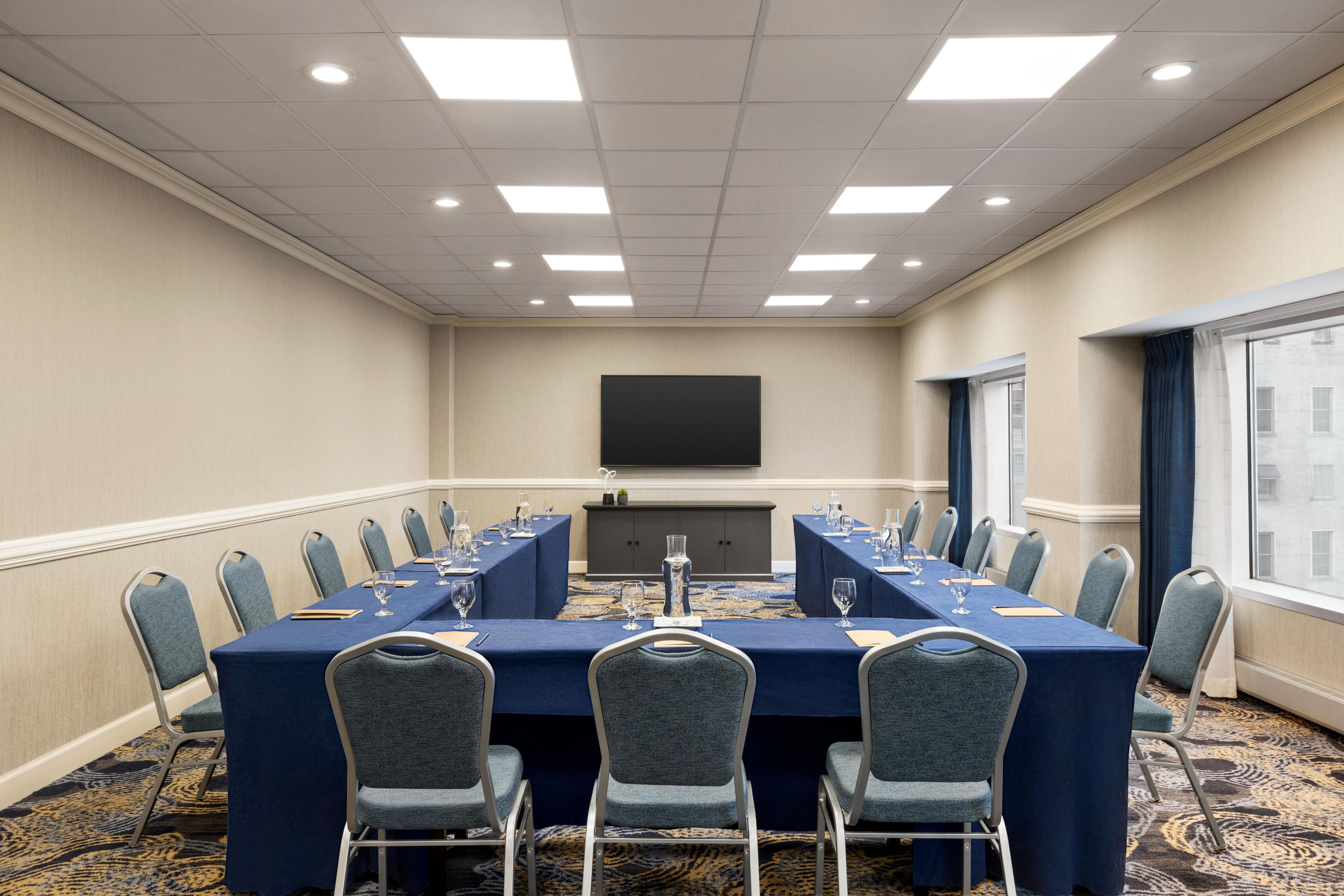 Meeting space with three long tables to accommodate a small group