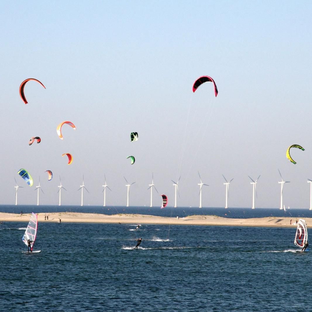 Windmills and kitesurfers at the Copenhagen shoreline