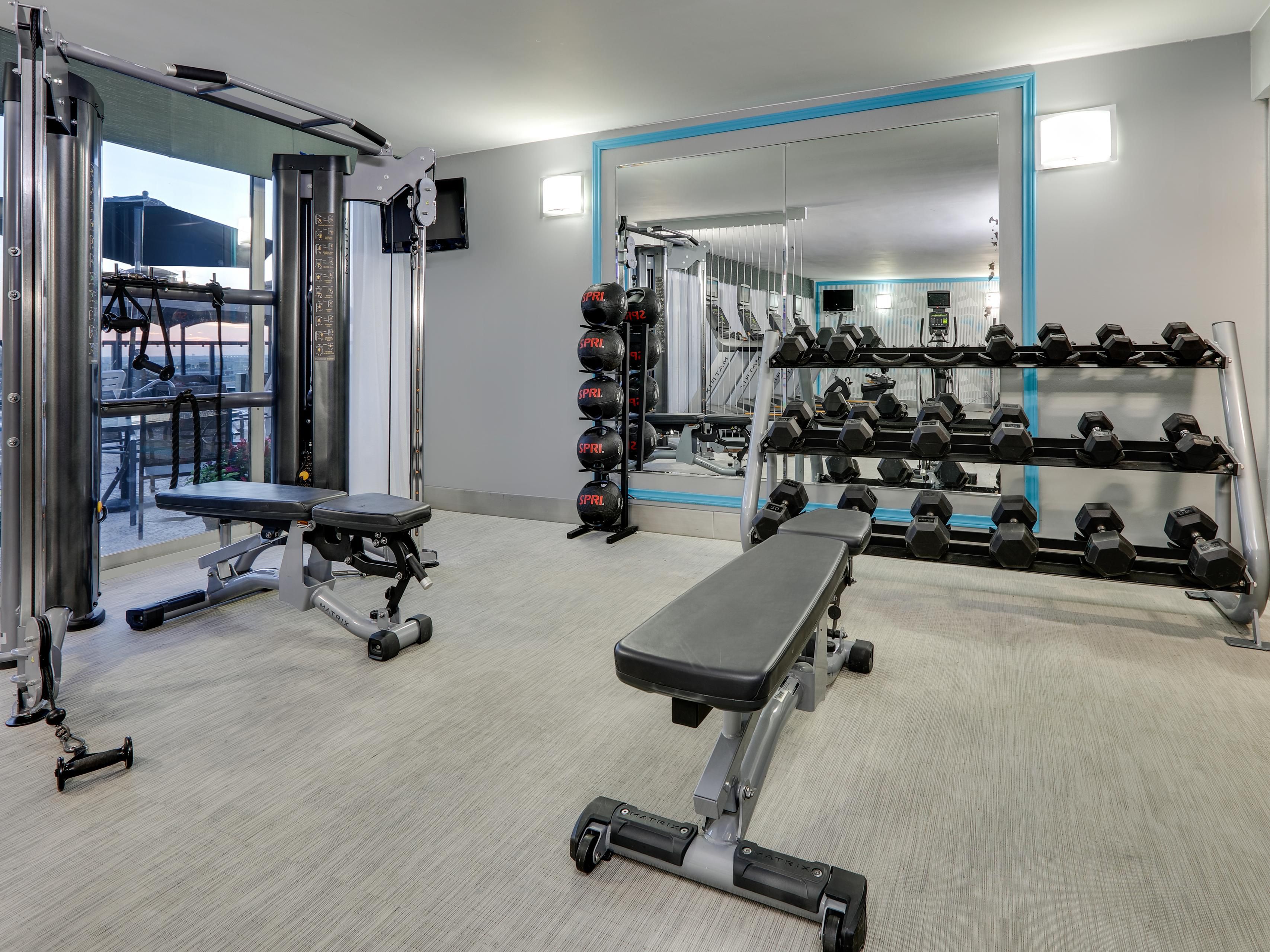 Build strength with weights and city views at our fitness center.