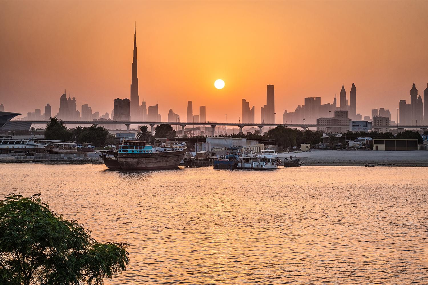 Stunning sunset with the glistening Dubai Creek and skyline
