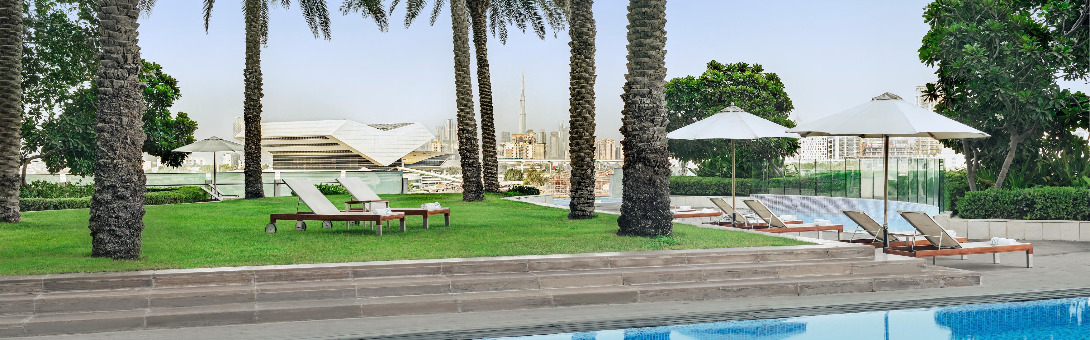 Swim in 25 meter pool and chill under palm trees with city view