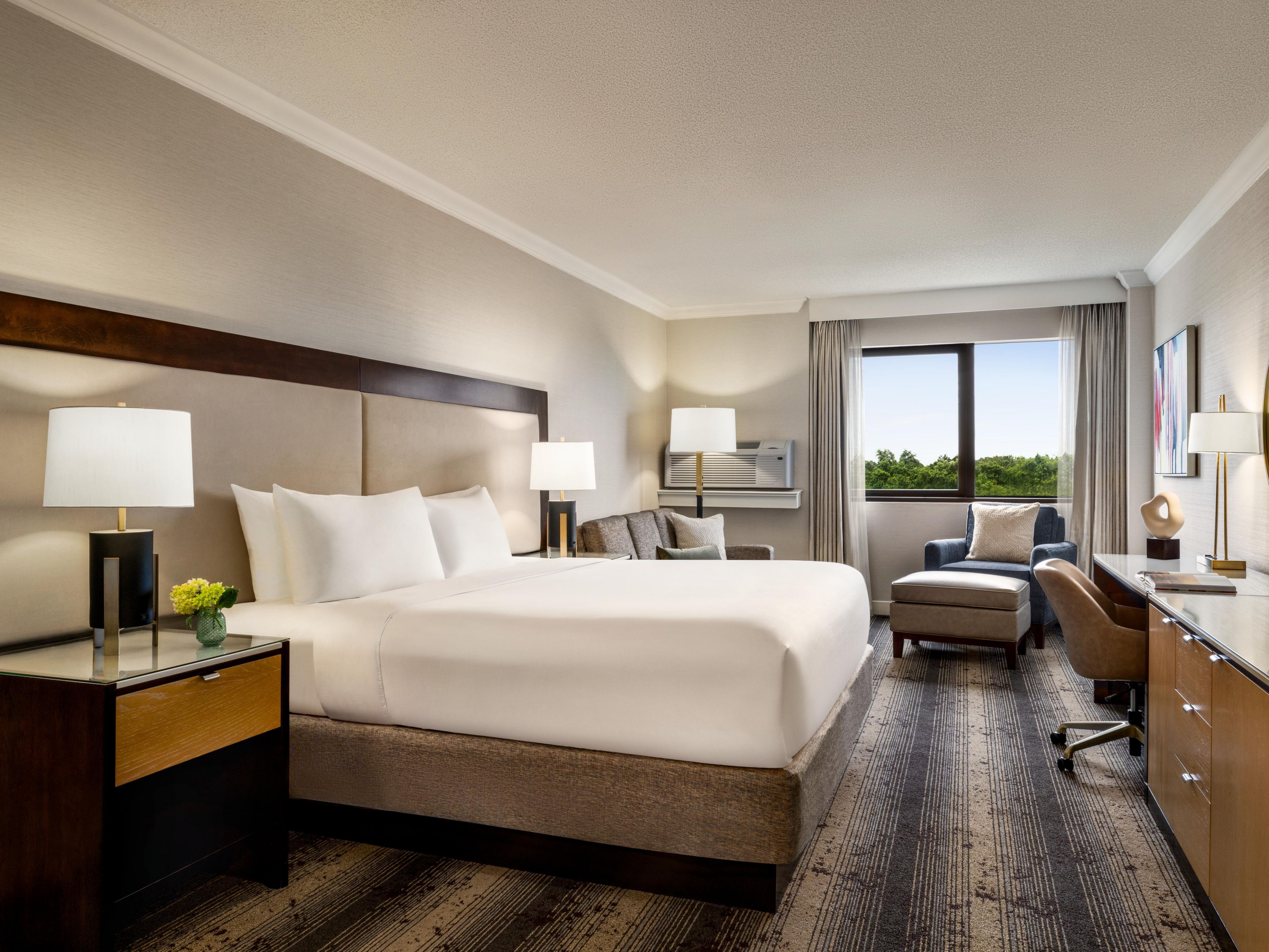 Relax in our king room with modern workspace and cozy seating.