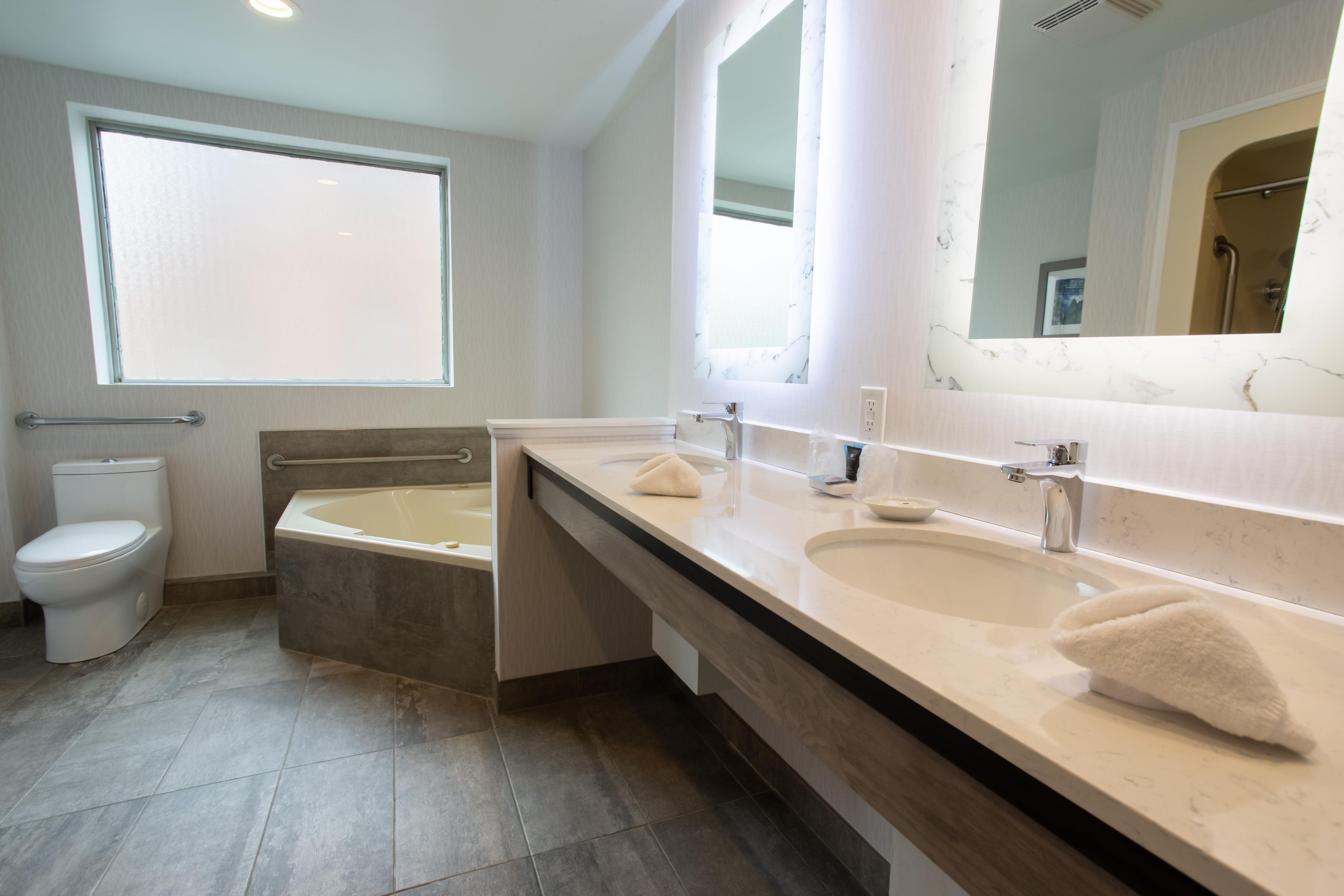 Spacious, marble-finished Bathroom in our Accessible Junior Suite