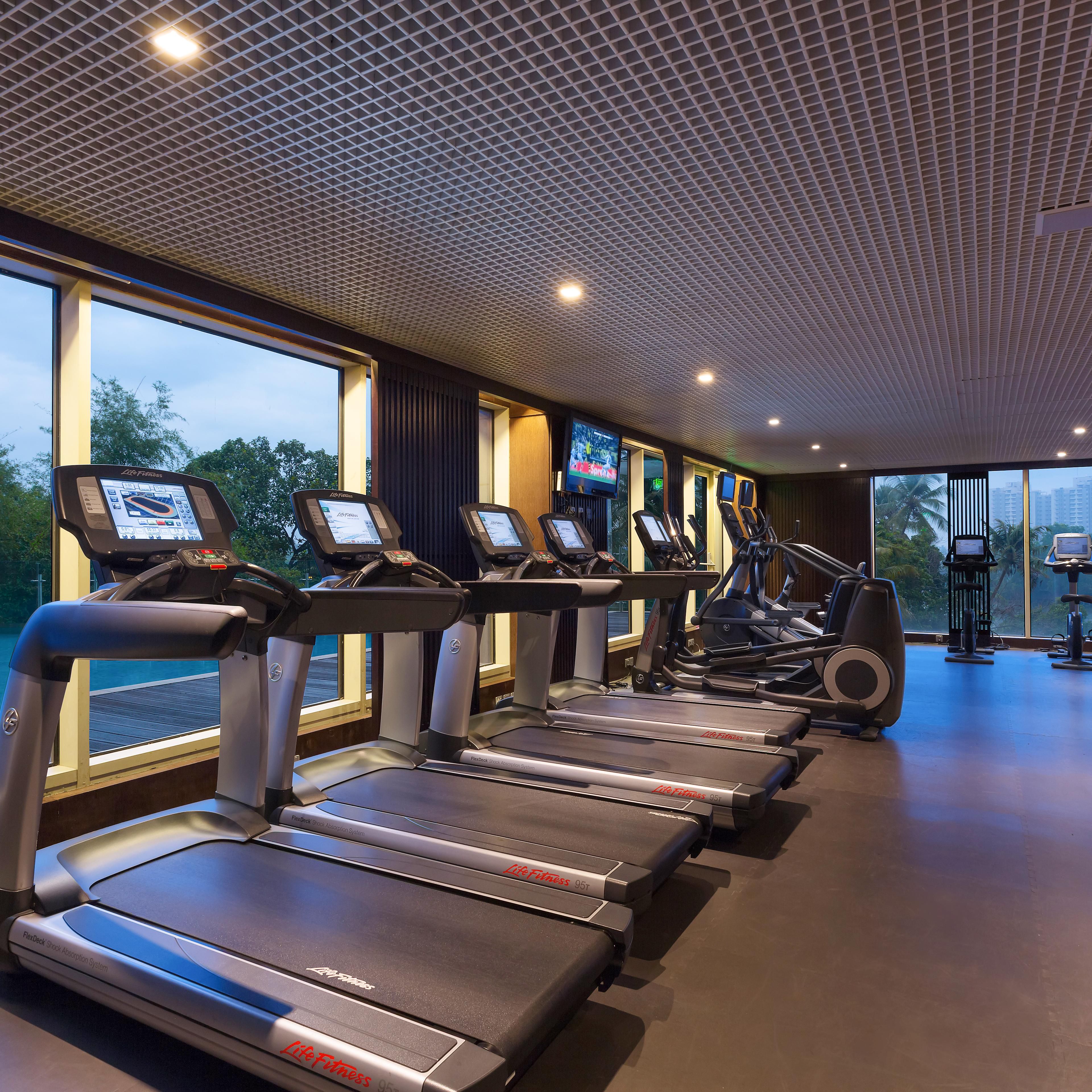 Work out with a panoramic view of the pool and greenery