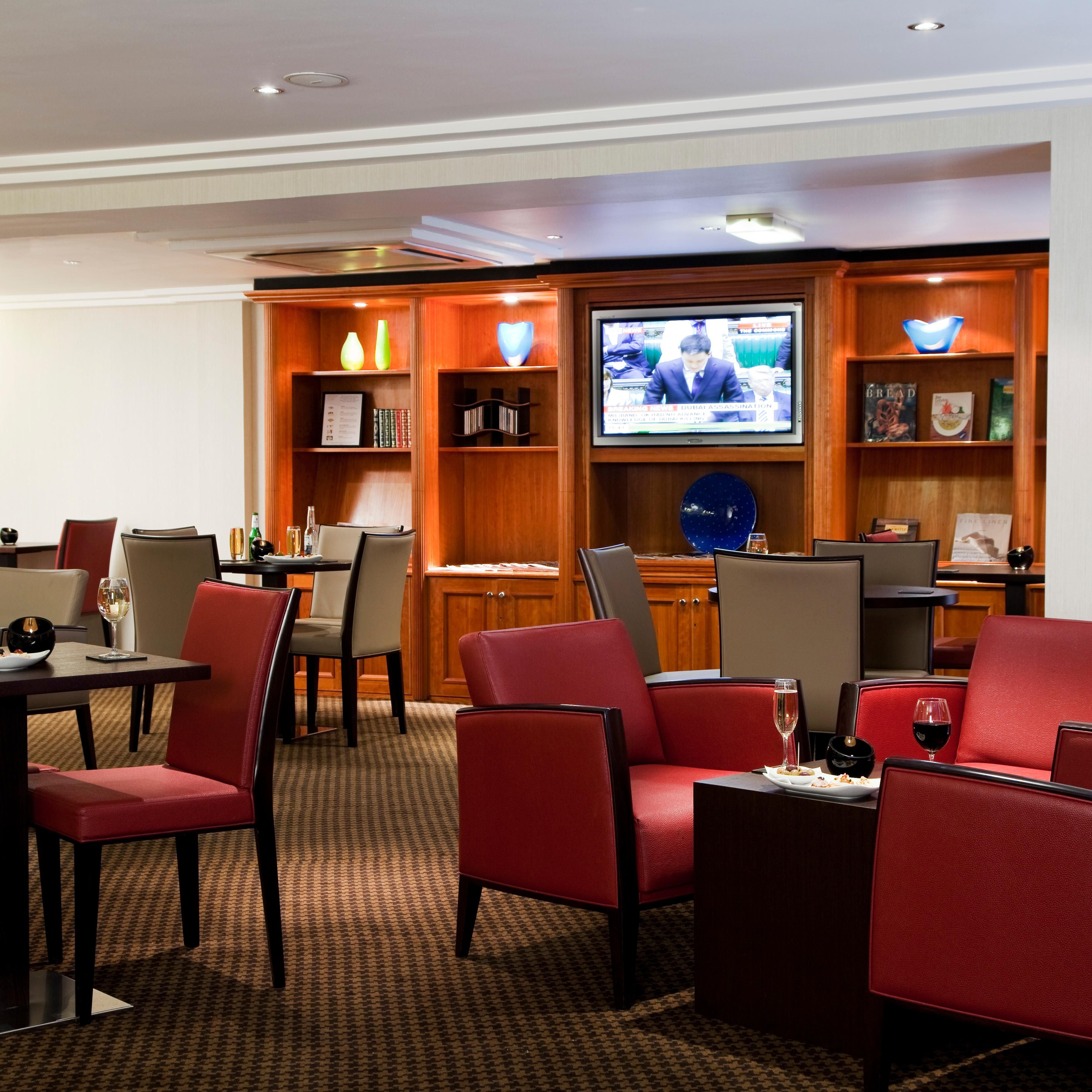 Large screen TV and international newspapers in Club Floor Lounge