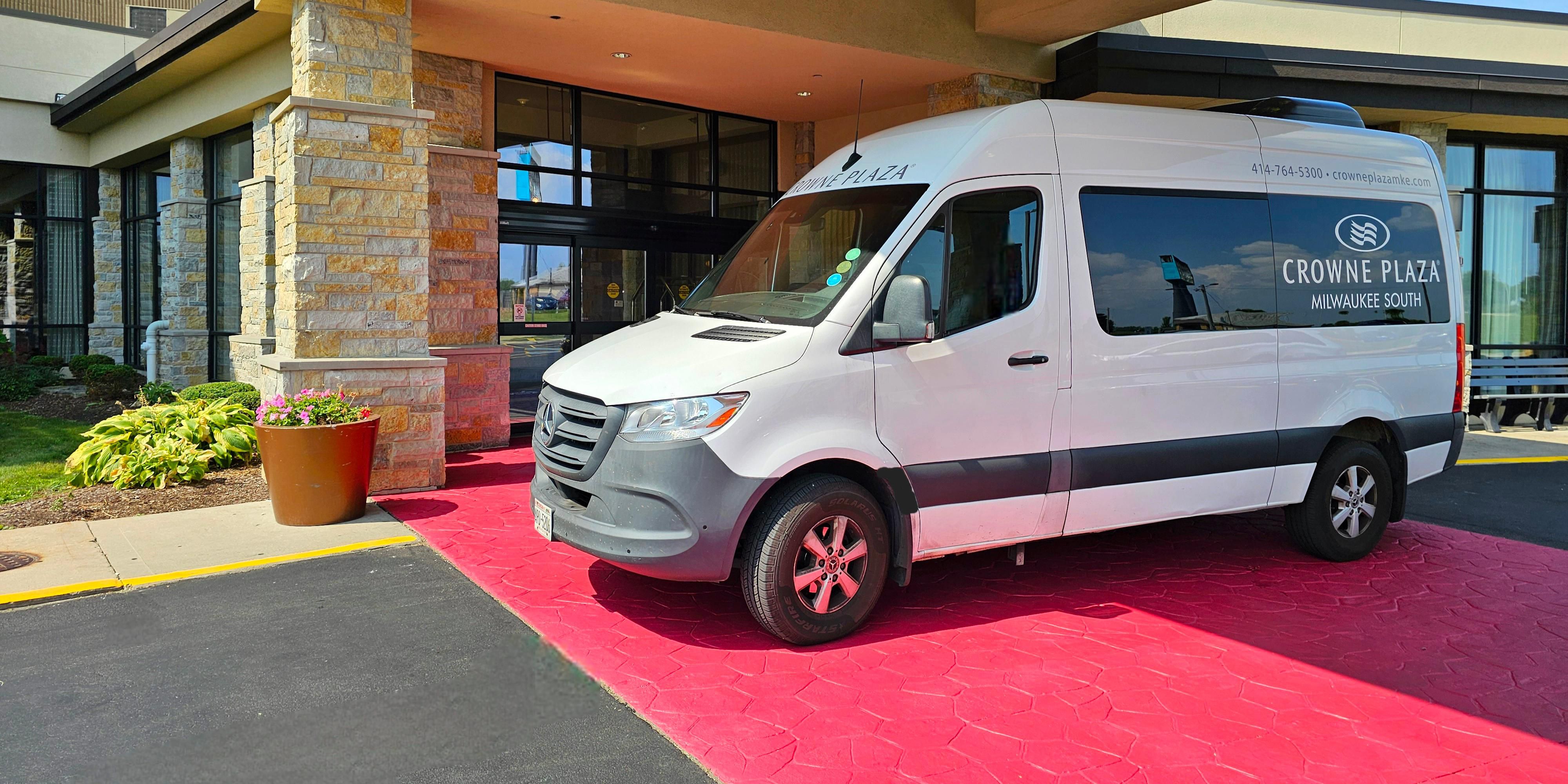 Shuttle bus waiting for guests in front of hotel.