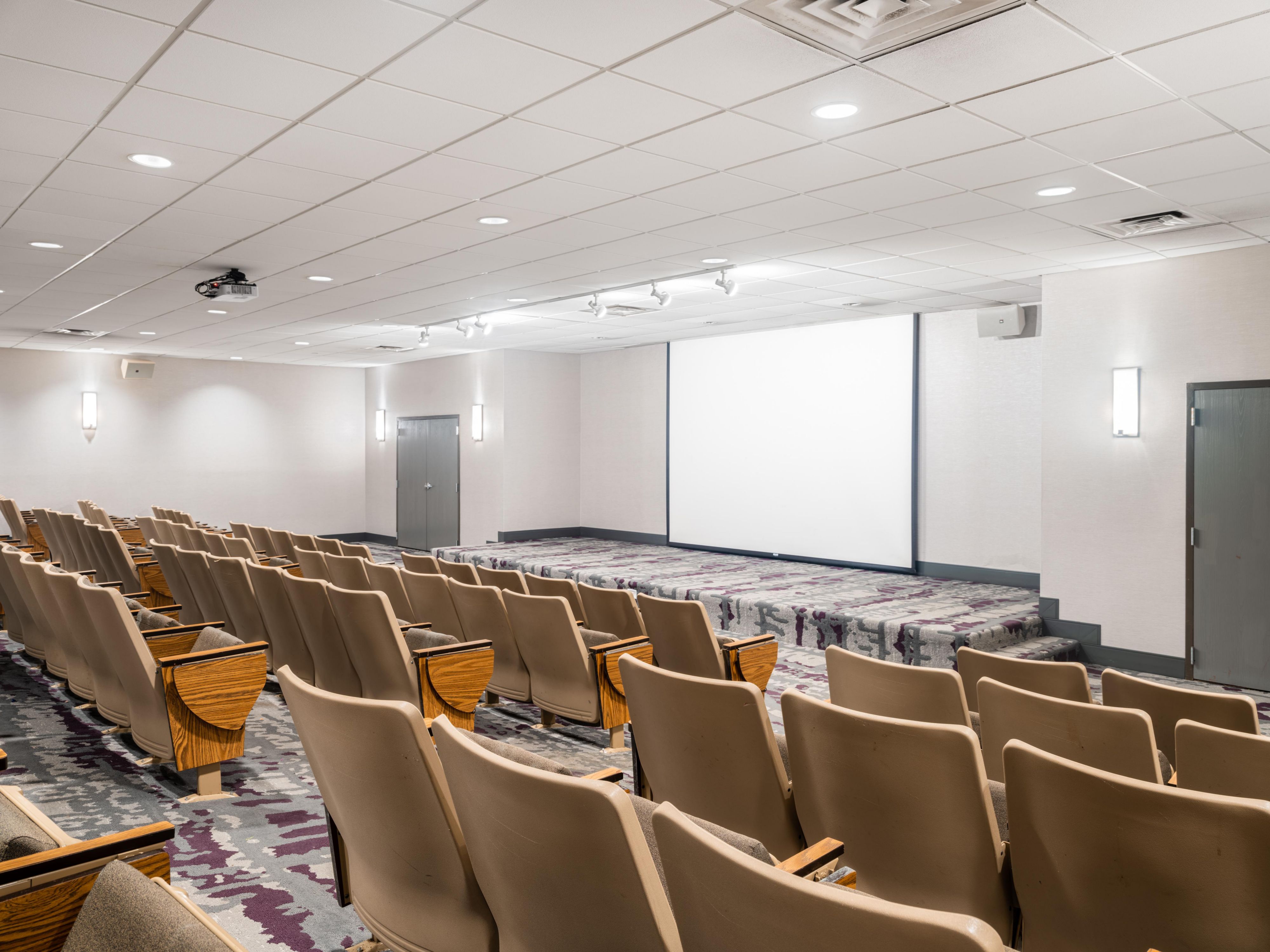 Meeting room with large screen and classroom style seating