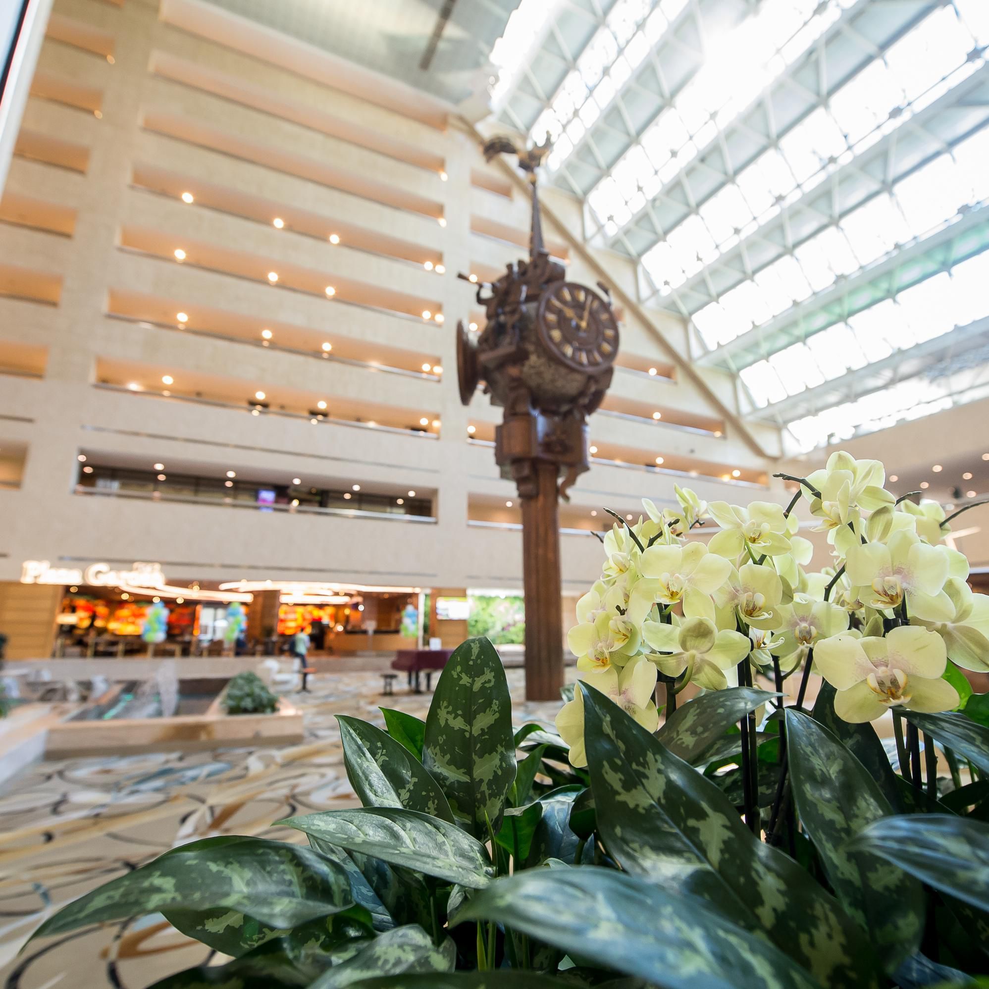 Signature clock in Hotel Atrium, lobby decorated with live flowers