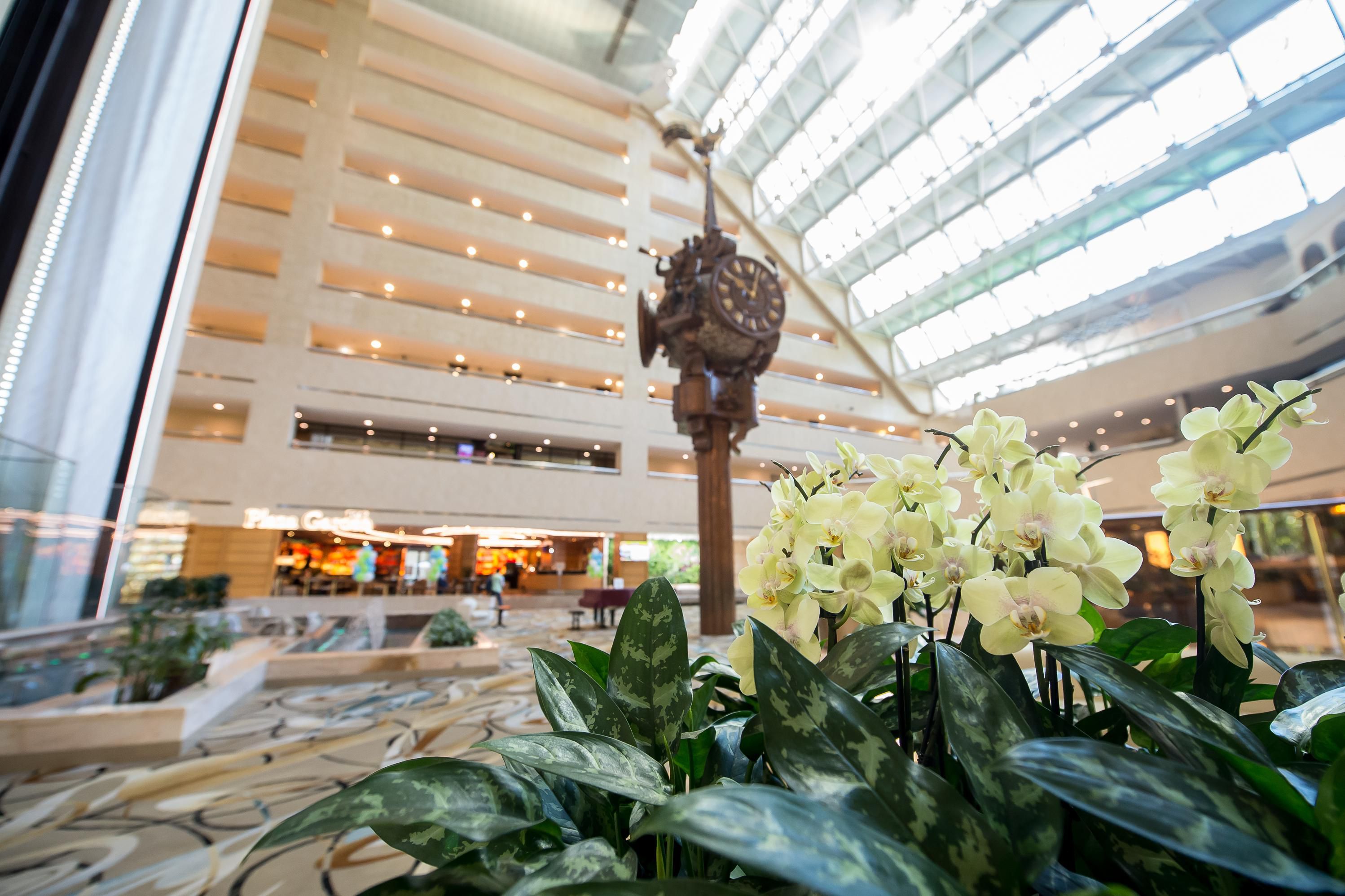 Signature clock in Hotel Atrium, lobby decorated with live flowers