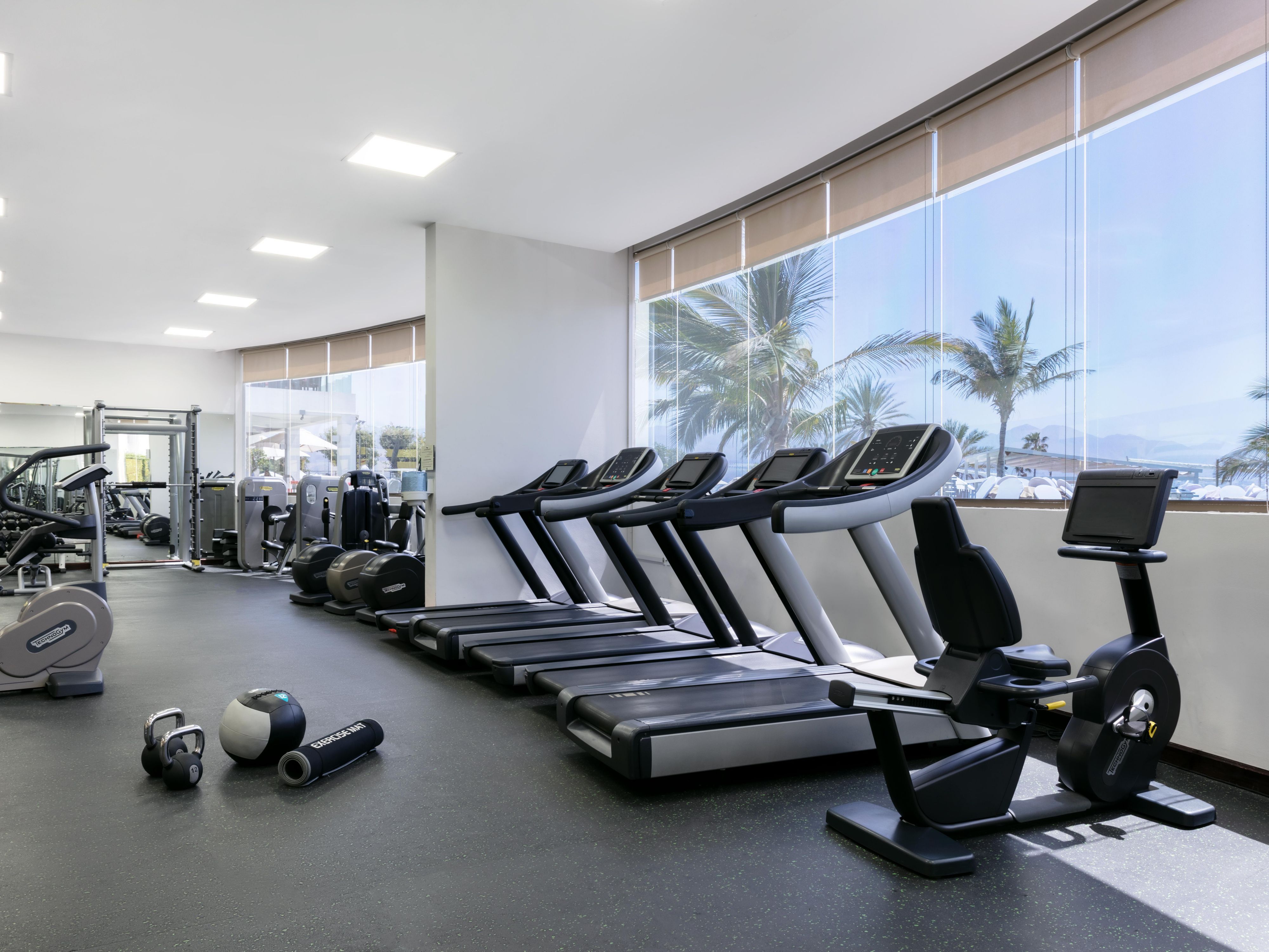 Stay active and refreshed with a modern fitness experience overlooking the sea