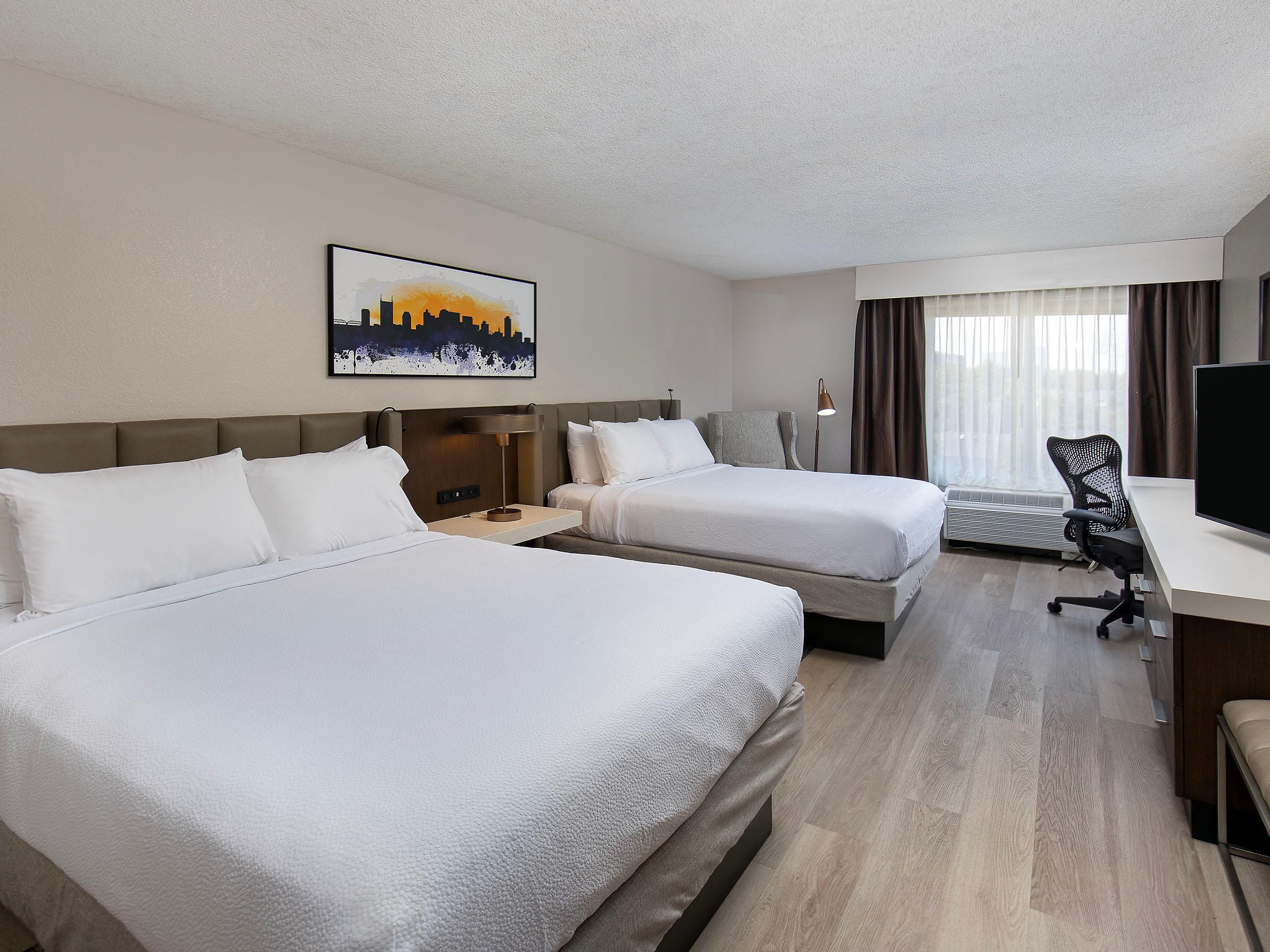 Designed for comfort and functionality, our double queen rooms feature two plush queen beds and contemporary furnishings, offering added space and a more refined experience than standard twin accommodations. Whether you're traveling with family, friends, or colleagues, enjoy a modern stay with effortless comfort.