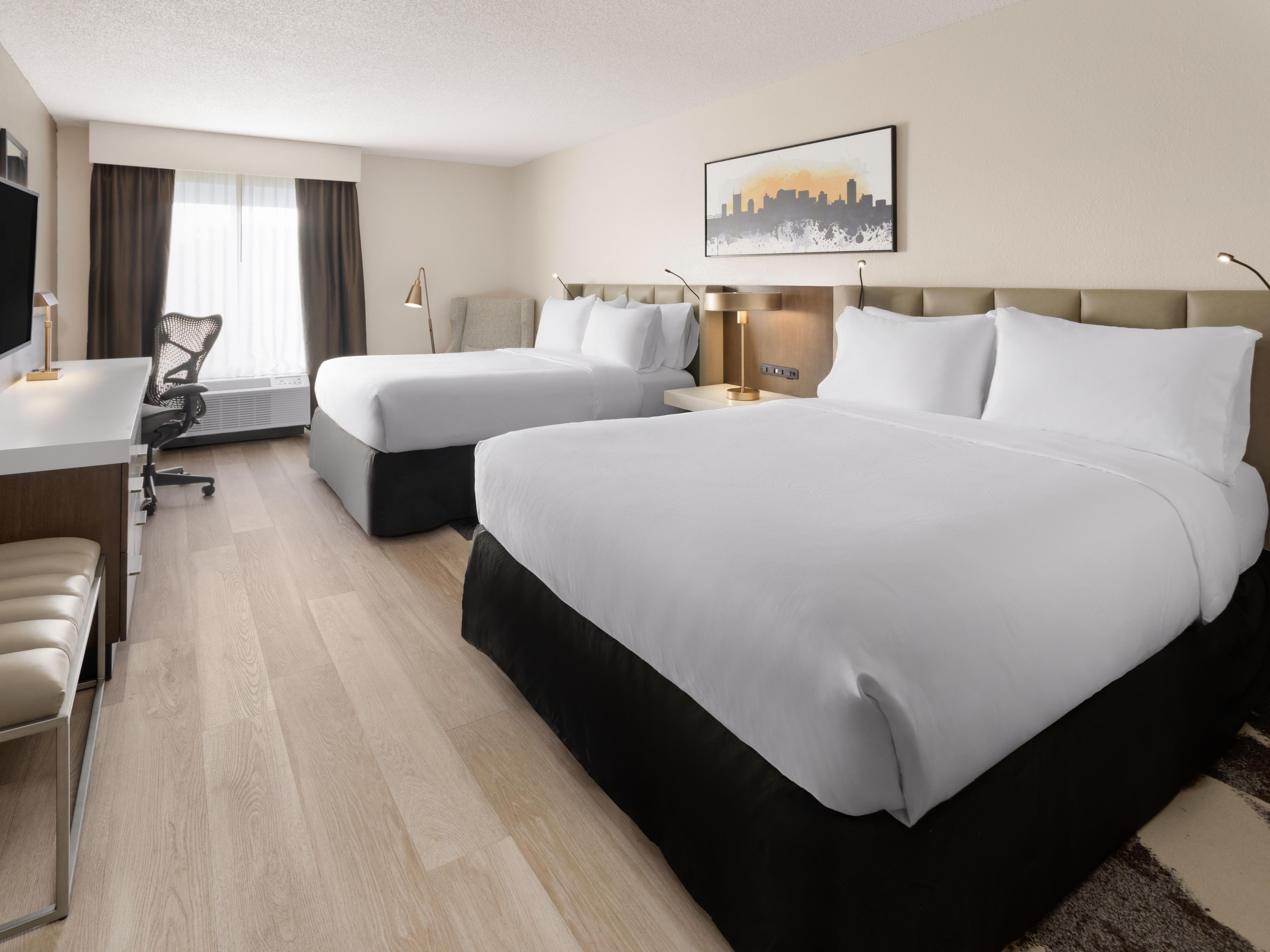 Designed for comfort and functionality, our double queen rooms feature two plush queen beds and contemporary furnishings, offering added space and a more refined experience than standard twin accommodations. Whether you're traveling with family, friends, or colleagues, enjoy a modern stay with effortless comfort.