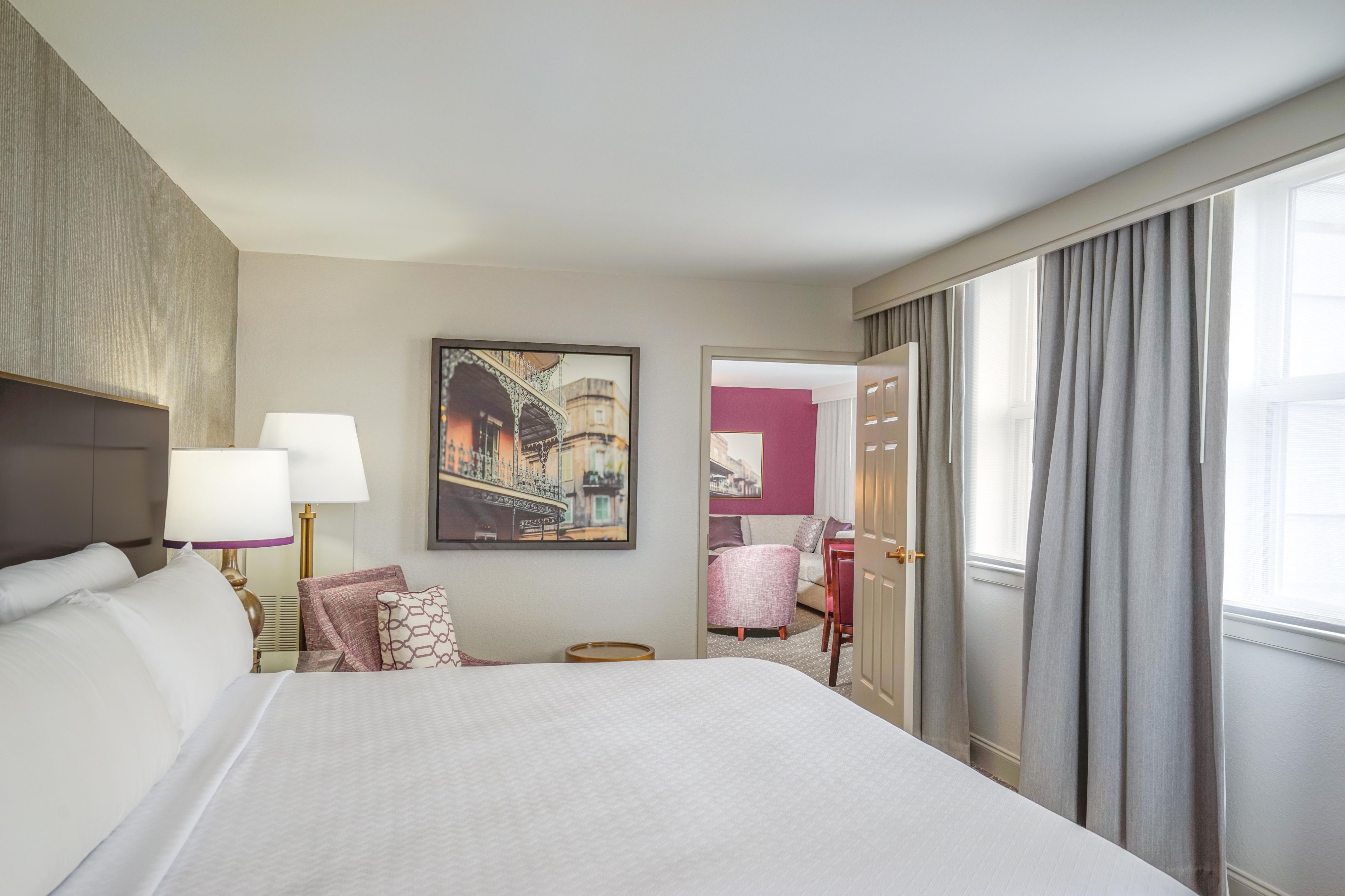 Hotel room with a bed and view into the seating area.