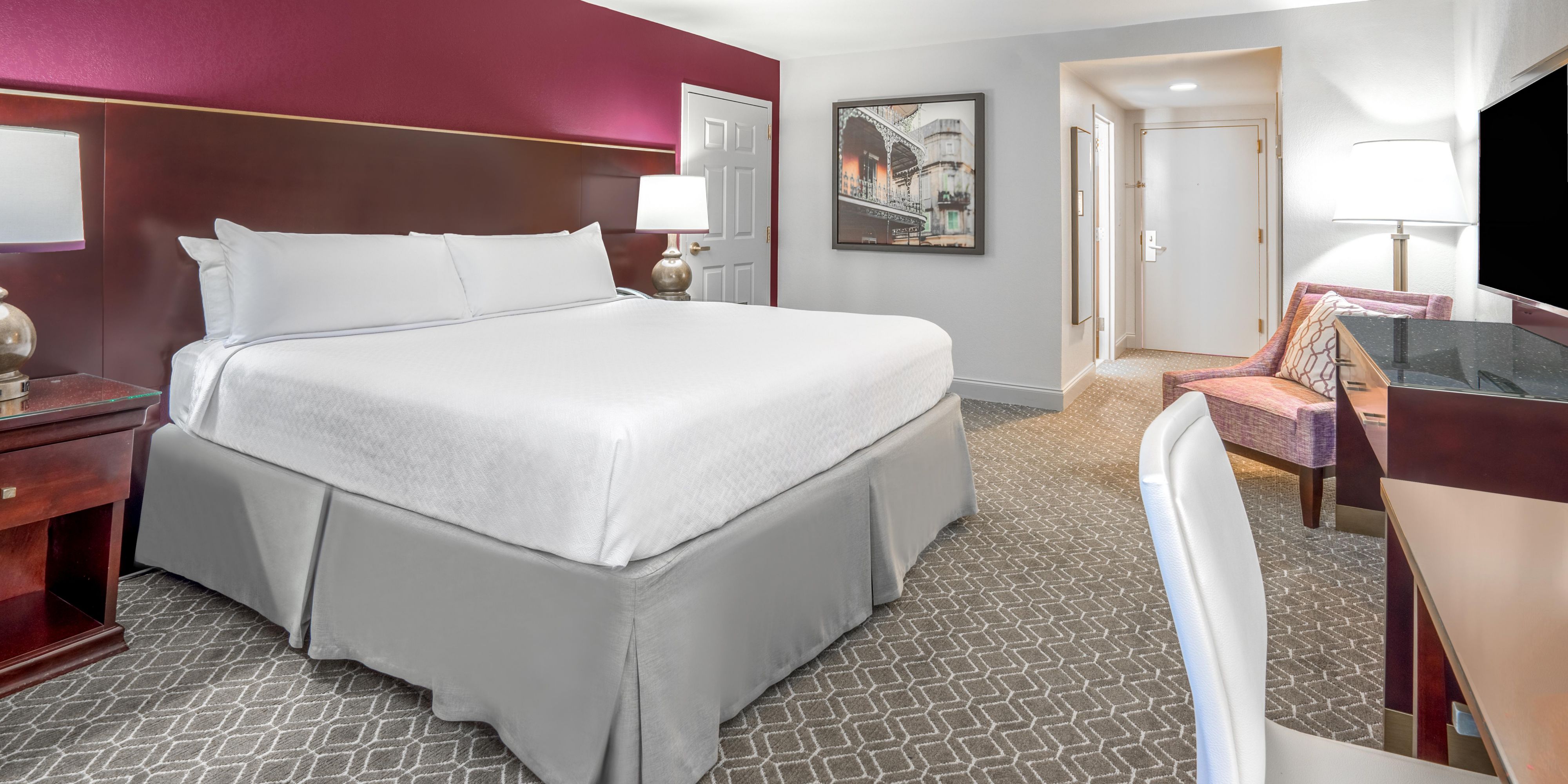 Premium king room with bed, desk, and seating area.