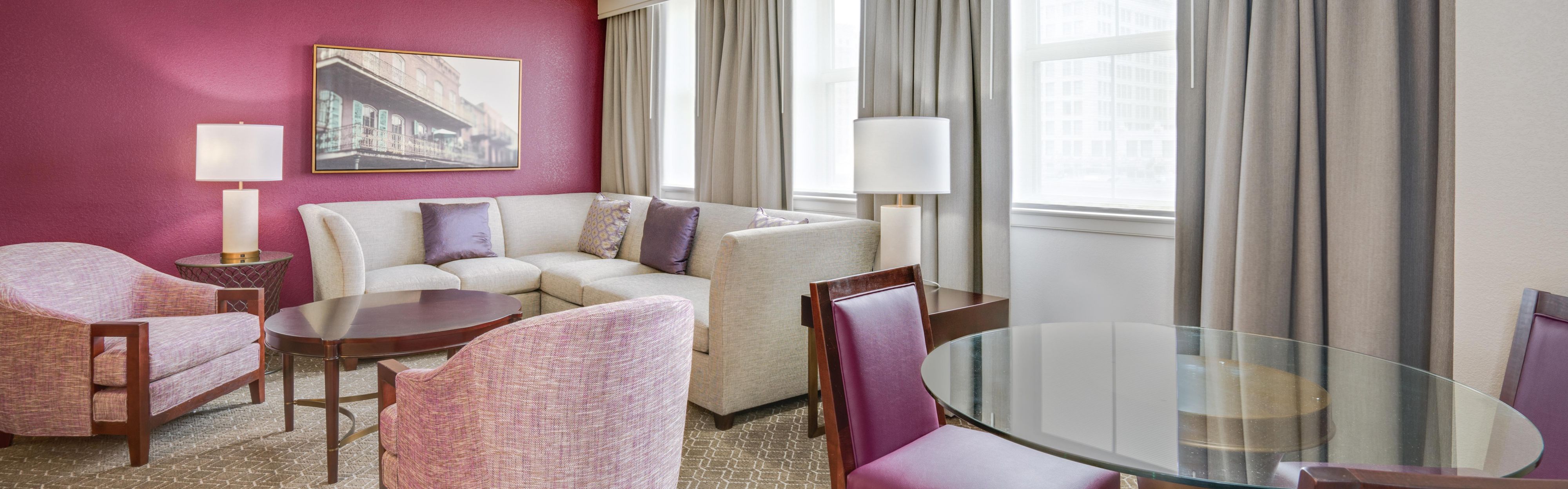 Hotel suite with living room and dining table.