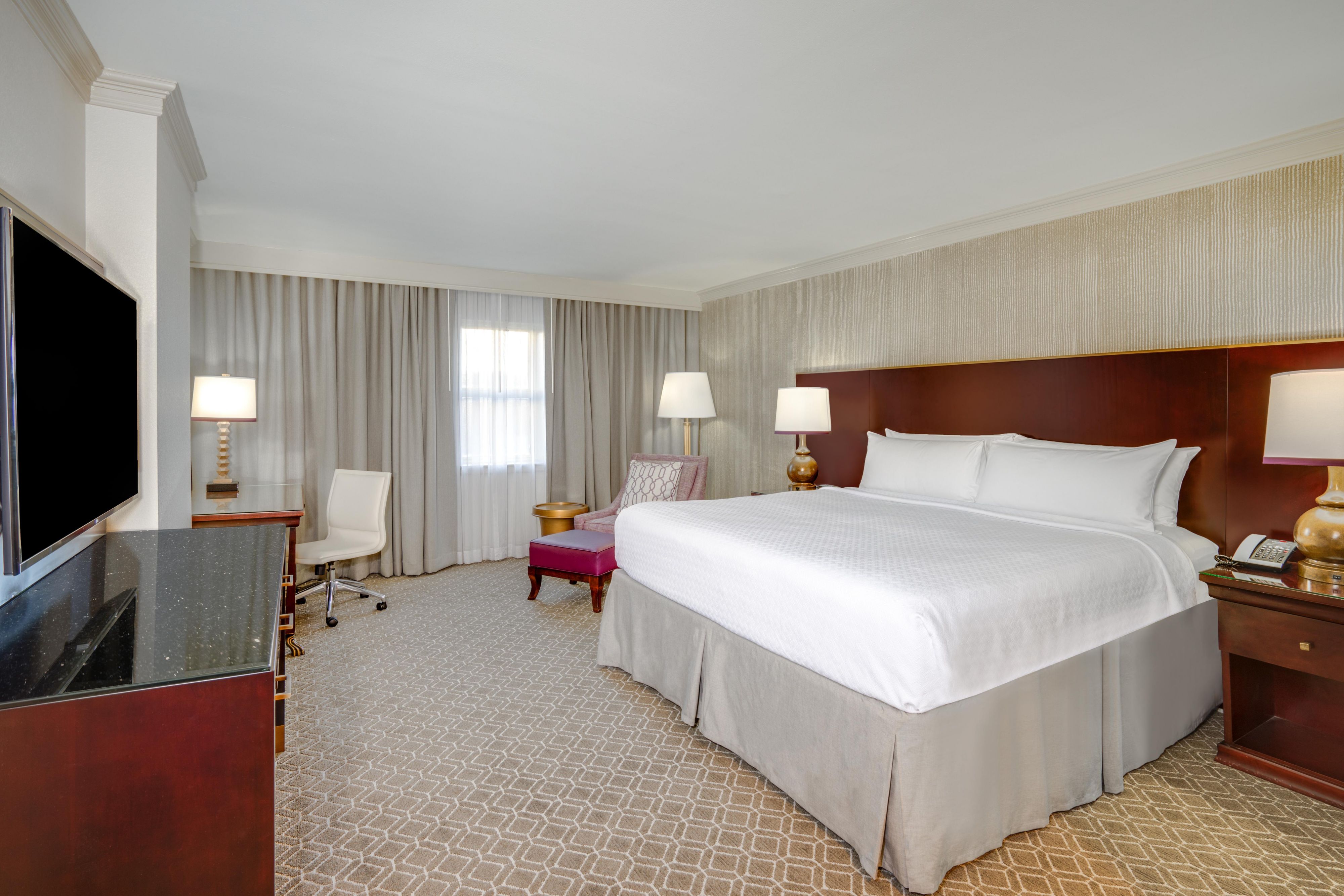 Premium king room with a king bed, seating, and desk.