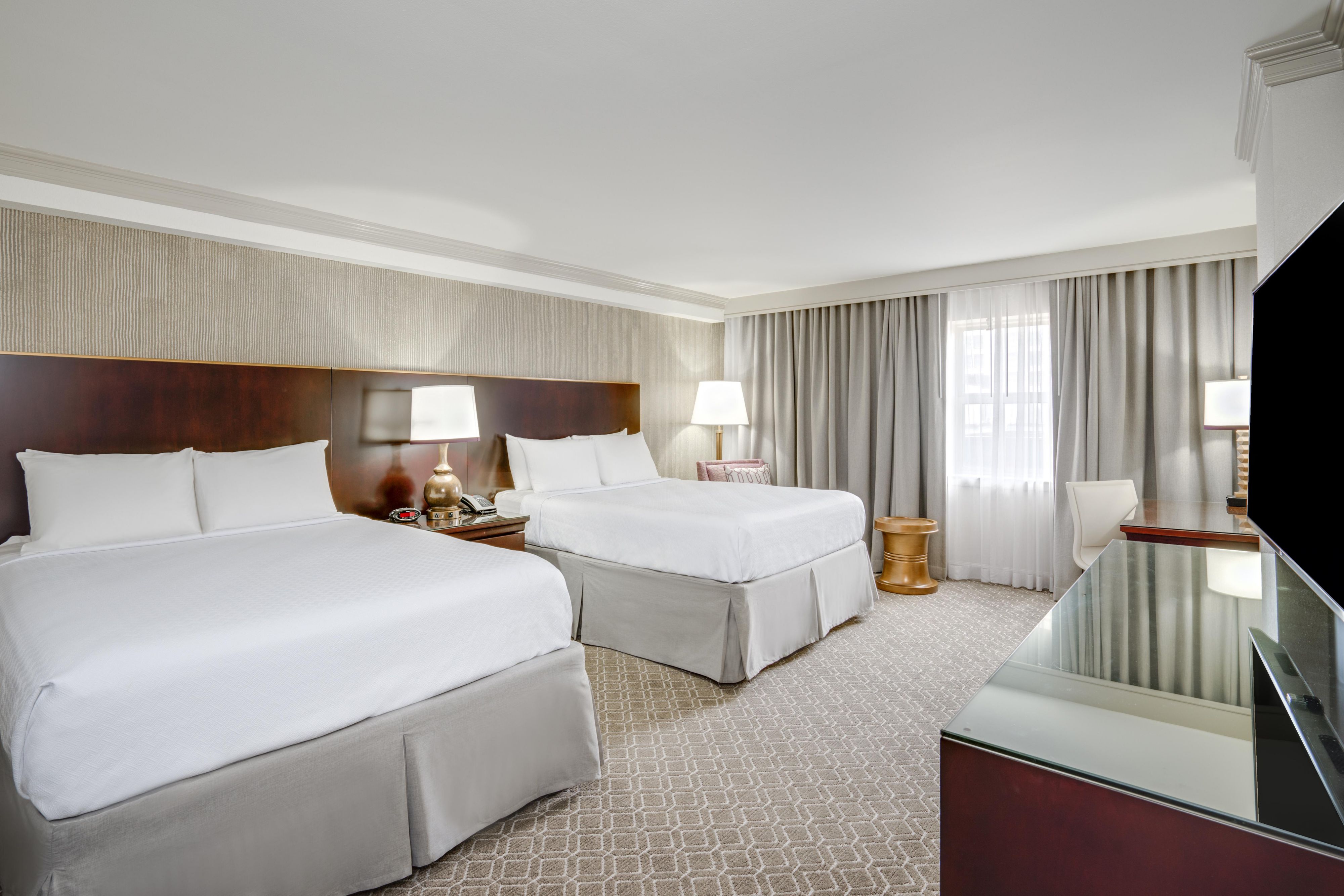 Premium queen hotel room with two beds.
