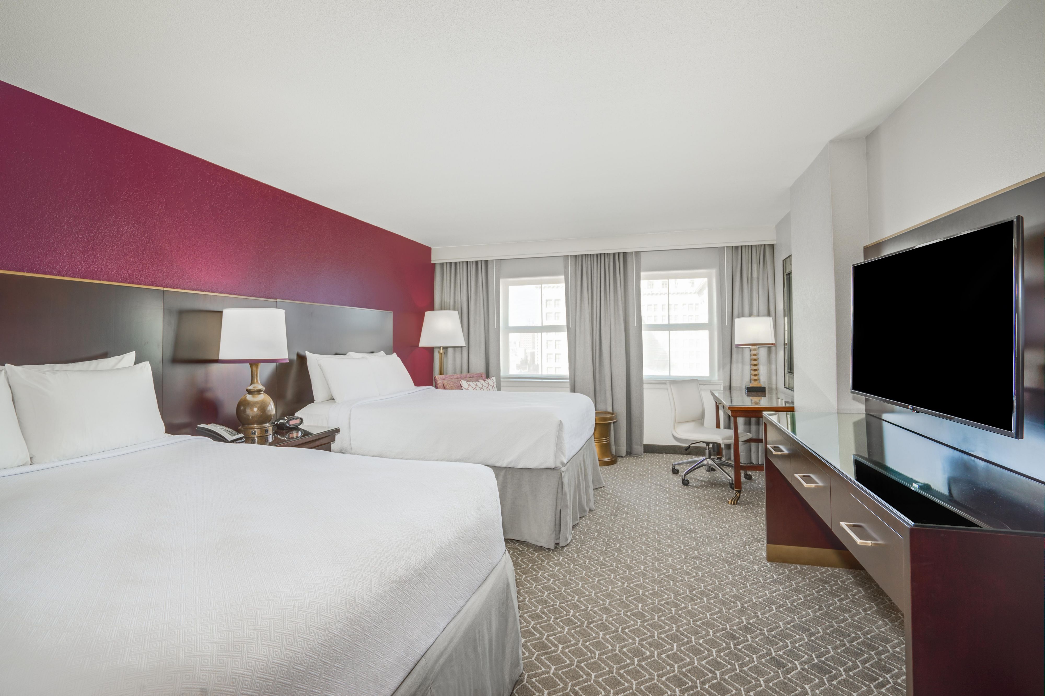 Premium queen hotel room with two beds.