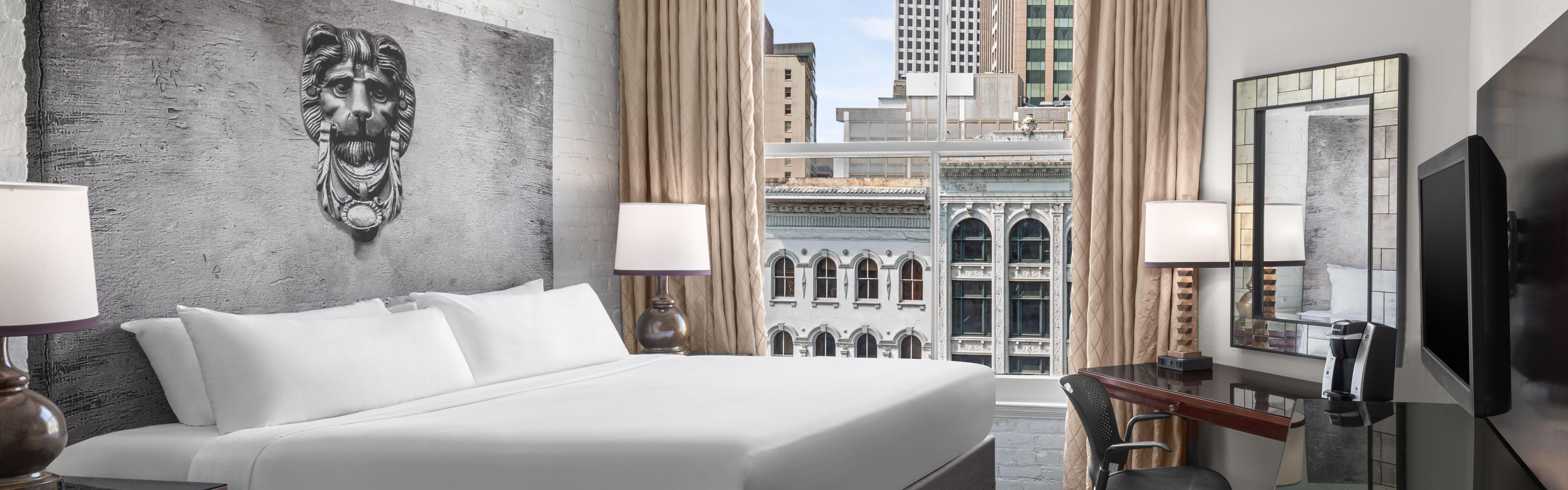 Bedroom with lion headboard and city view.