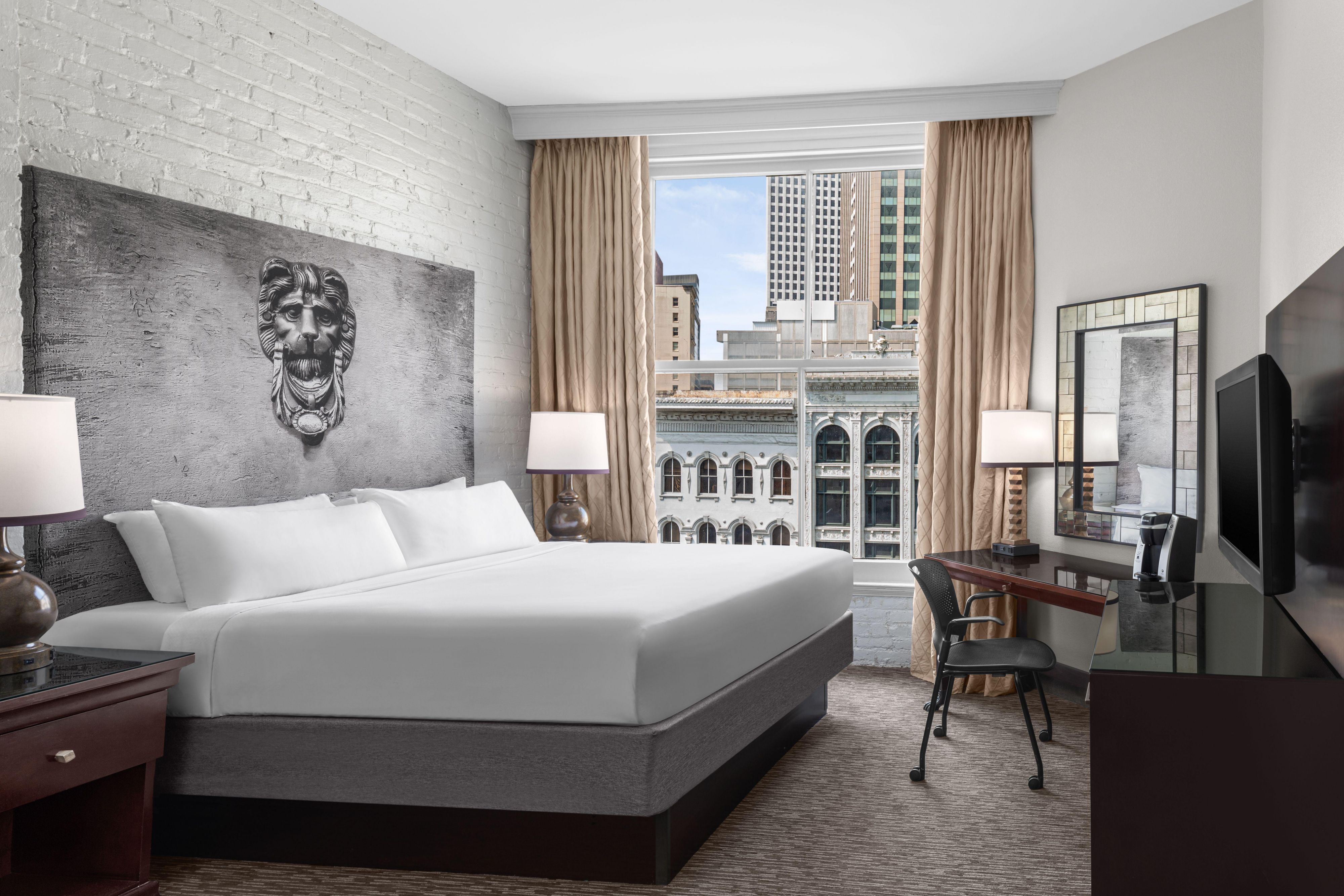 Guestroom with queen bed overlooking French Quarter